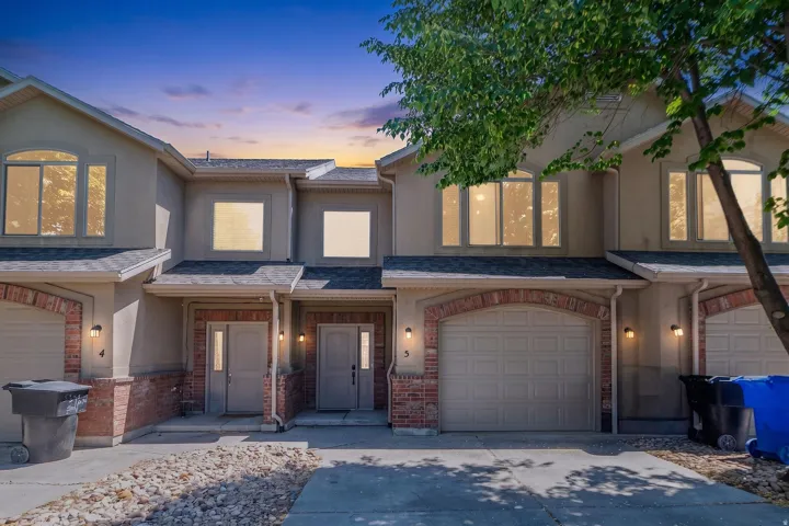 Townhome exterior with stucco and brick facade