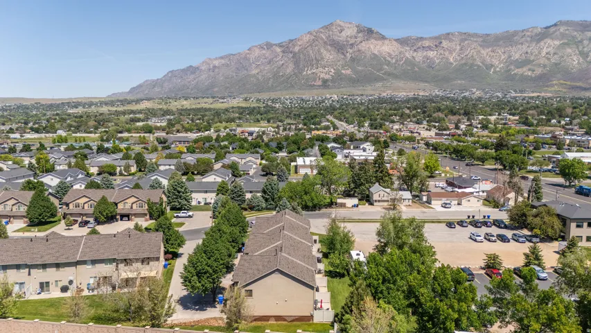 Expansive aerial perspective showcasing residential properties with a mountainous backdrop