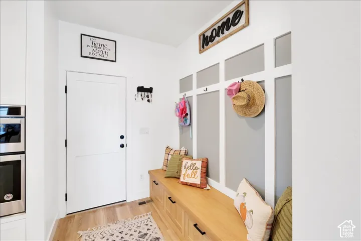 Built-in mudroom bench with wood-finish top and integrated storage drawers