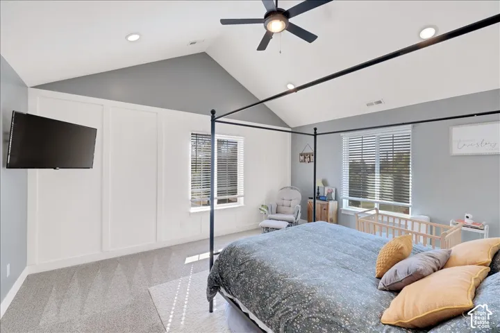 Vaulted ceilings with recessed lighting and a ceiling fan