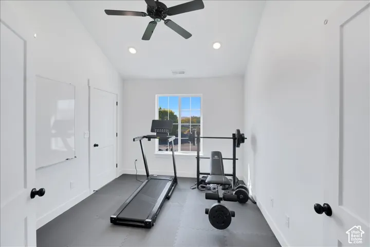 Bright room featuring a window, recessed lighting, and a ceiling fan