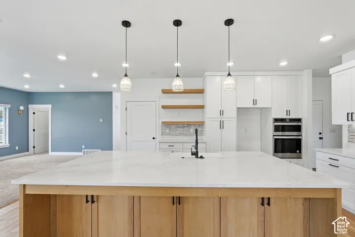 Spacious kitchen island featuring a light-toned countertop and wood-finish cabinetry