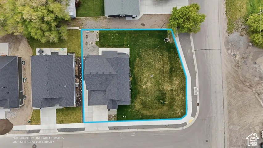 Corner lot property with a dark shingle roof and a concrete driveway