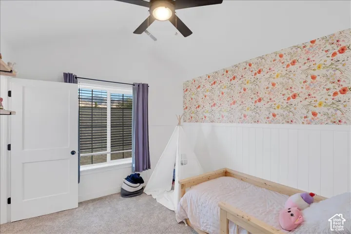Vaulted ceiling featuring a ceiling fan with integrated lighting