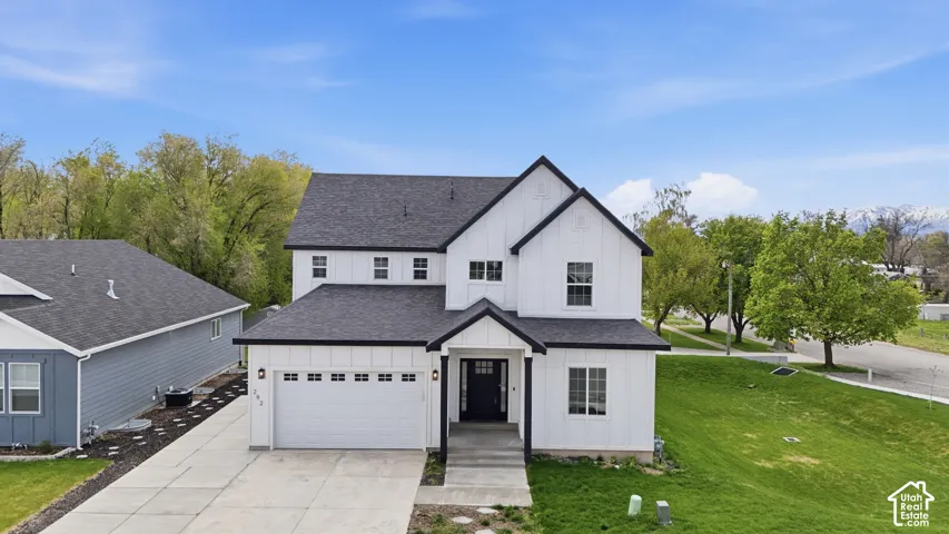 Modern farmhouse exterior with white board and batten siding and black trim accents