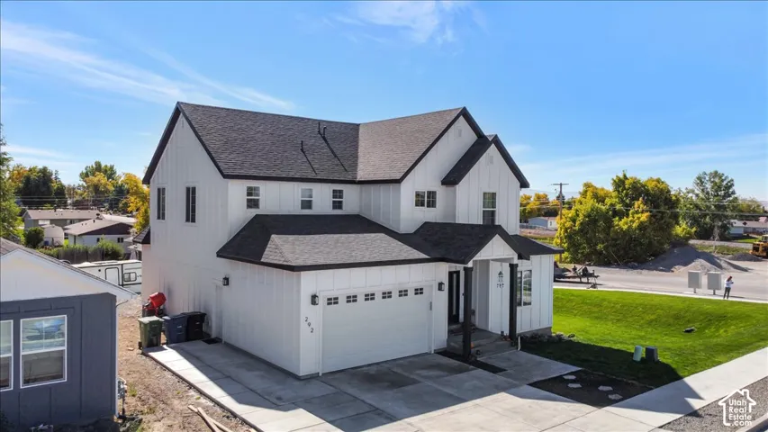 Modern farmhouse exterior featuring white board-and-batten siding with dark trim accents