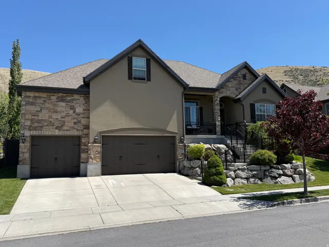 Stucco and stone facade with a multi-car garage