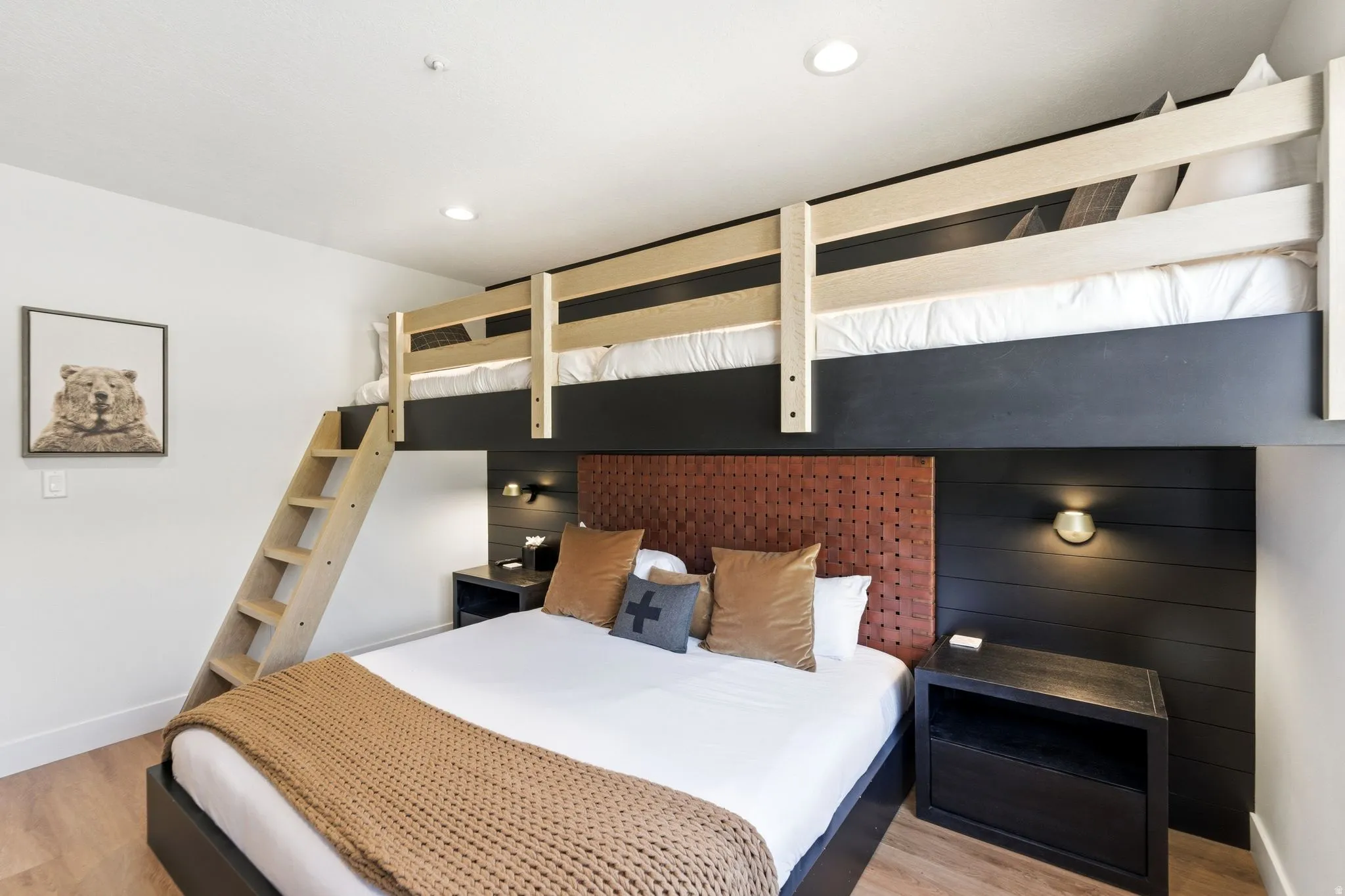 Bedroom featuring wood-finish flooring, a built-in bunk bed with a ladder, recessed ceiling lighting, and wall-mounted sconce lighting