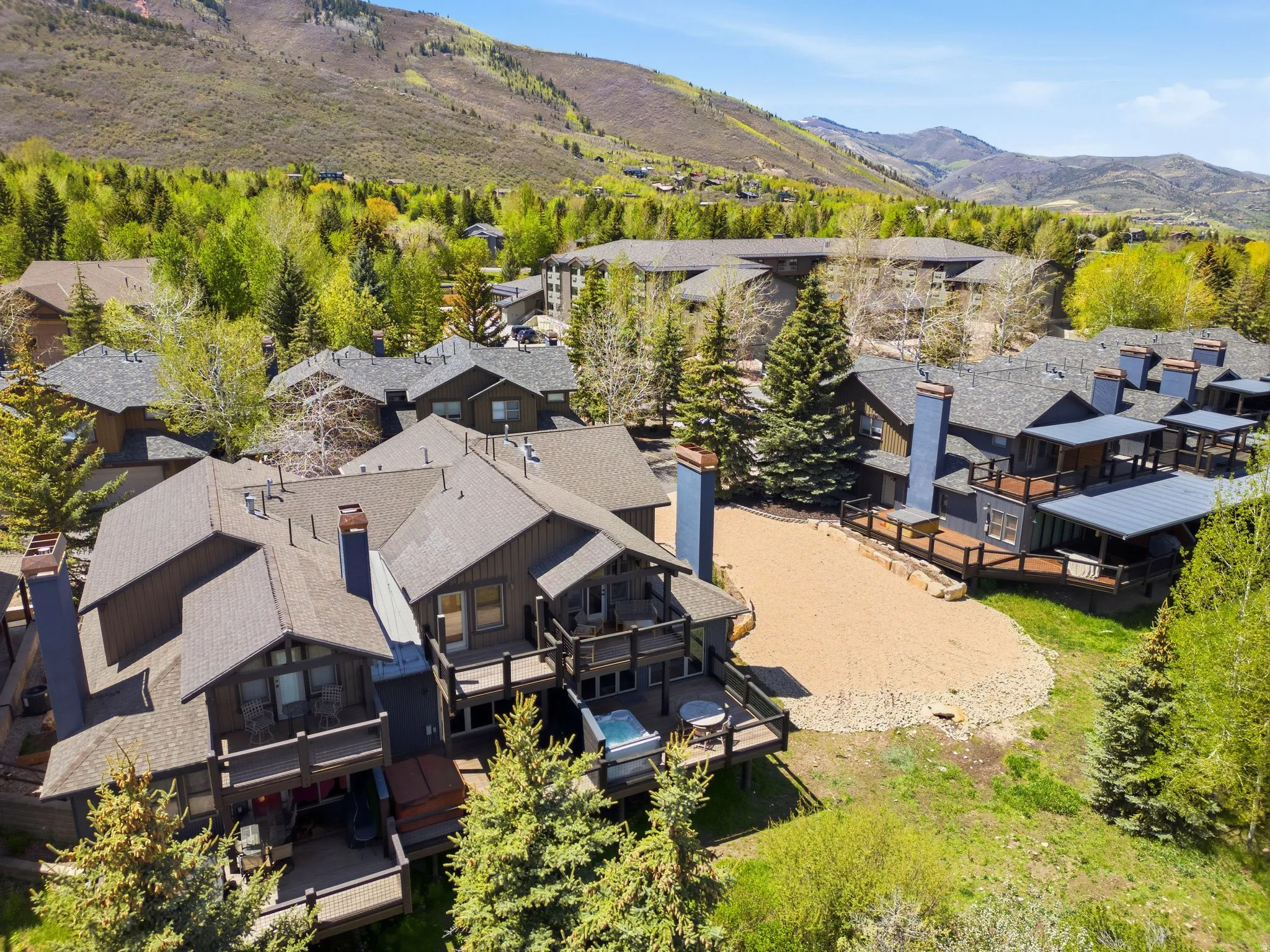 Contemporary multi-level residence featuring dark-toned siding and multiple outdoor decks