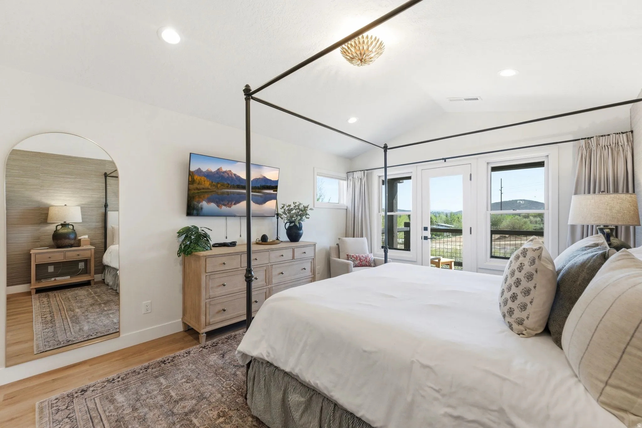 Vaulted ceiling room with recessed lighting and a decorative chandelier