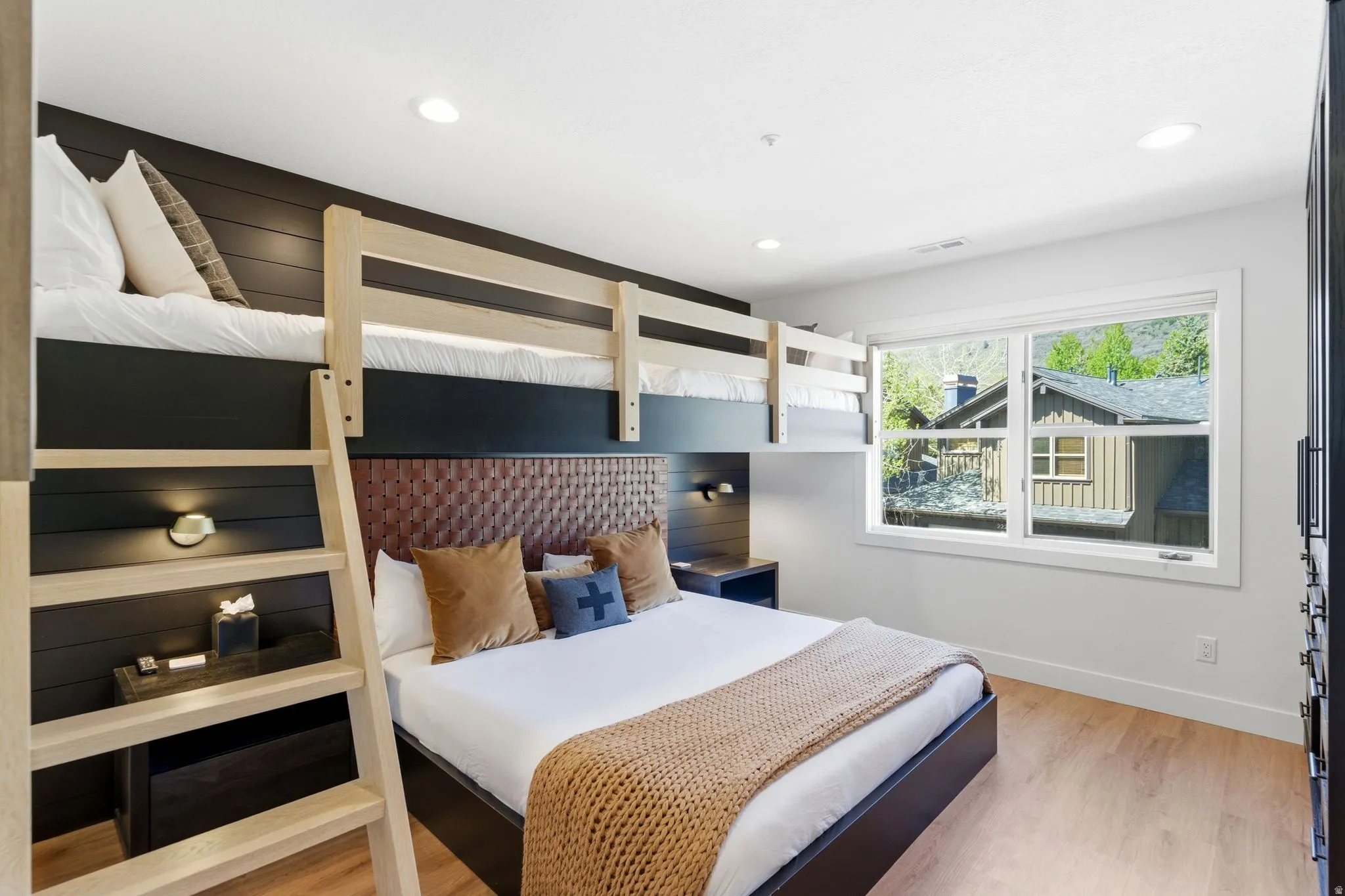 Bedroom featuring built-in bunk beds with natural wood framing