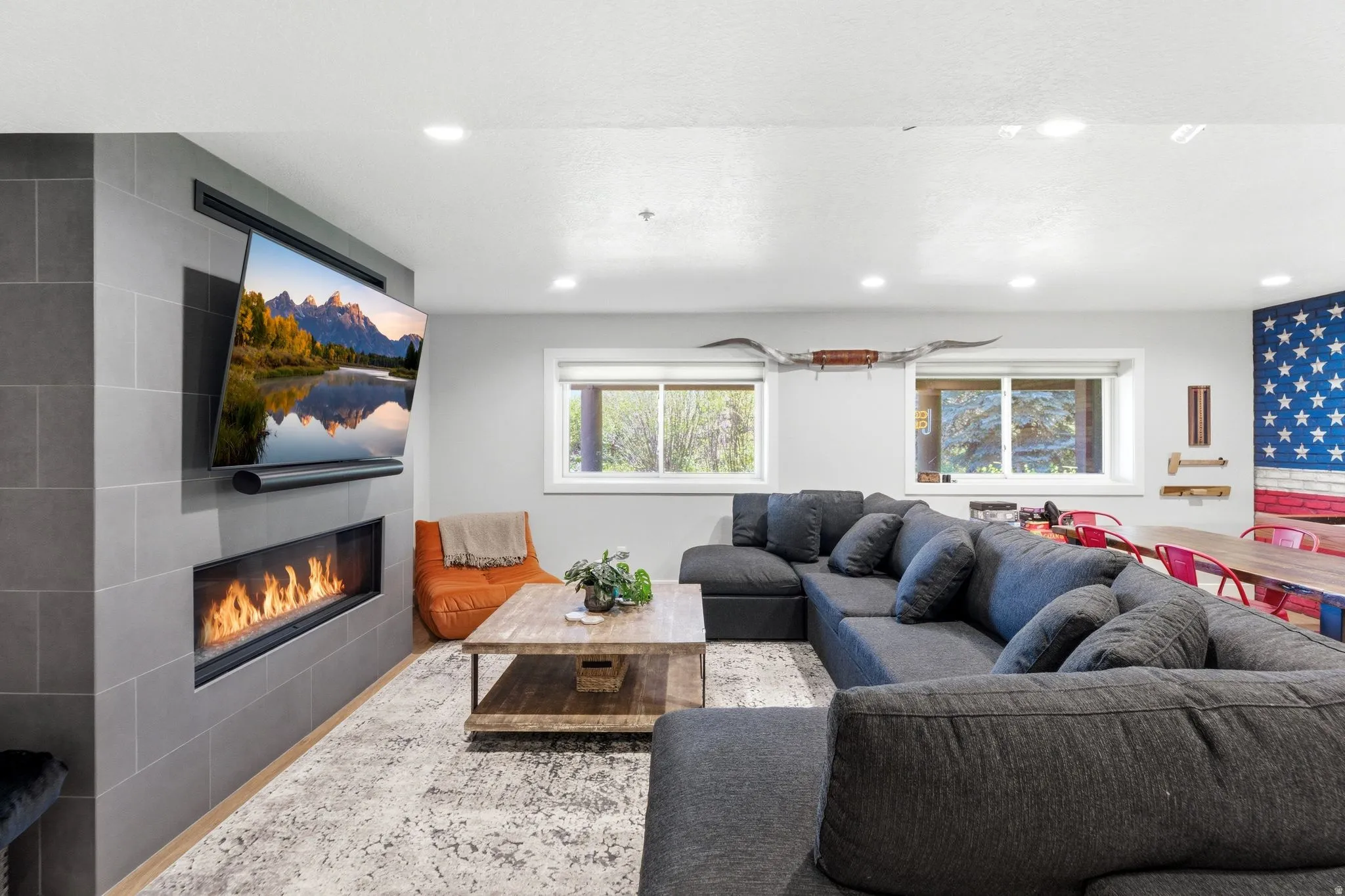 Living area featuring a floor-to-ceiling tiled fireplace surround with an integrated linear fireplace