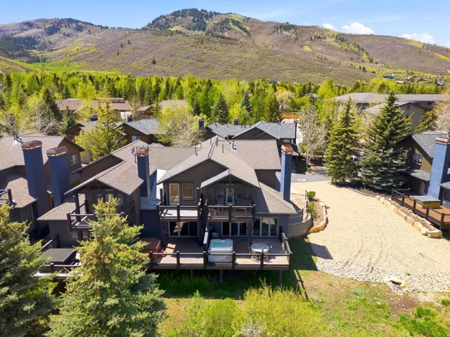 Multi-level property with dark-toned siding and multiple outdoor decks