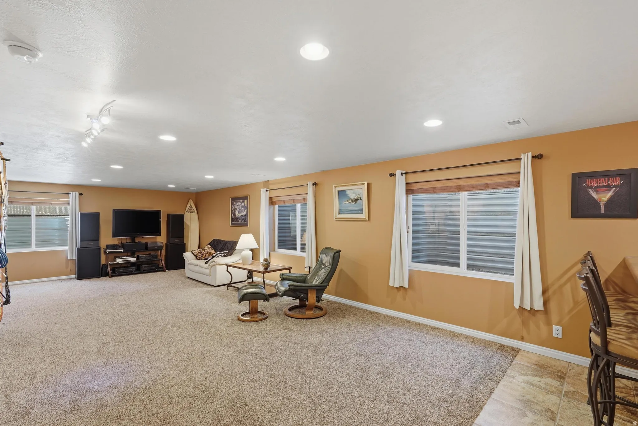 Spacious lower-level area featuring recessed lighting and neutral carpet