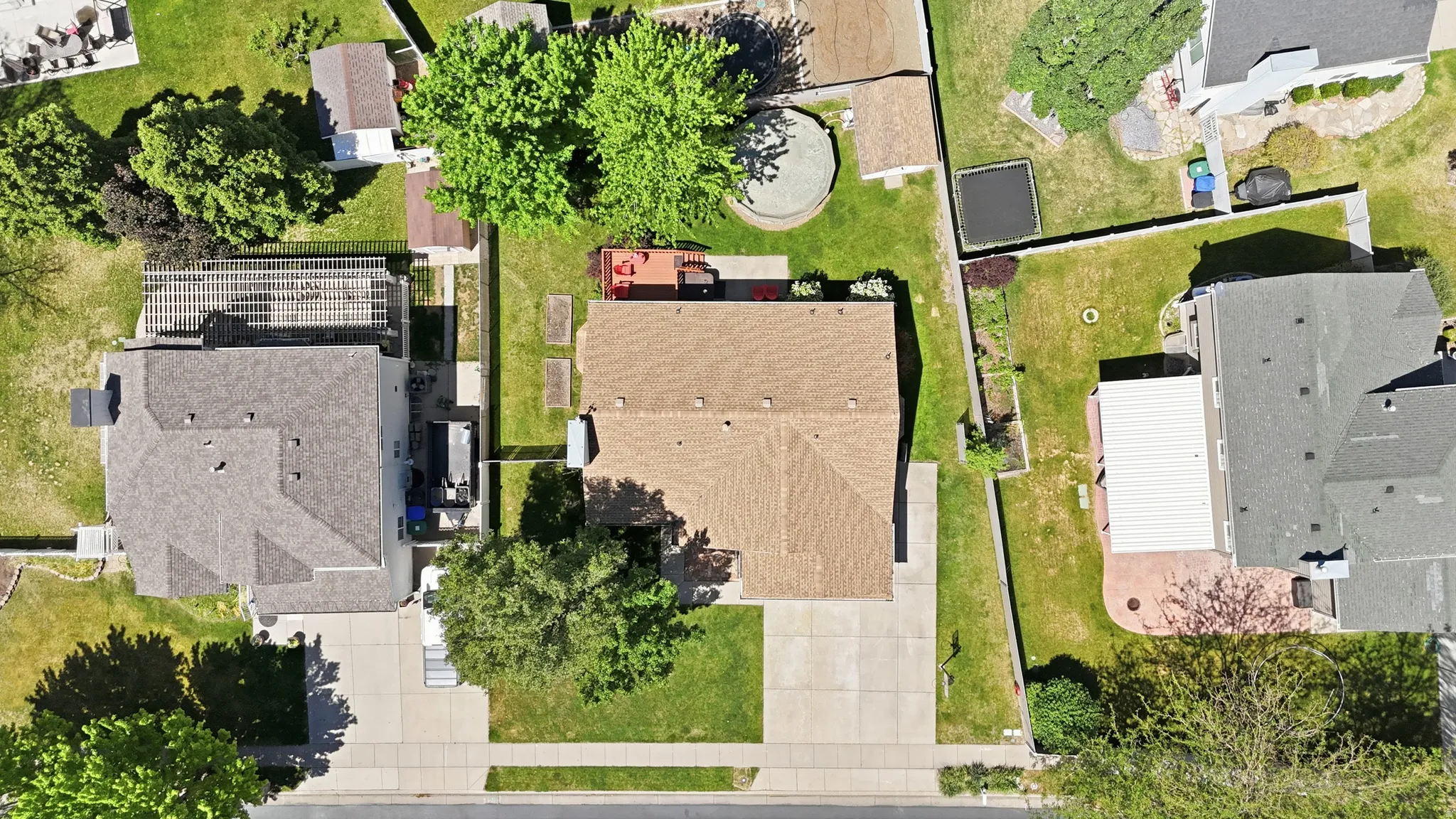 Expansive property featuring a brown shingle roof and a spacious backyard