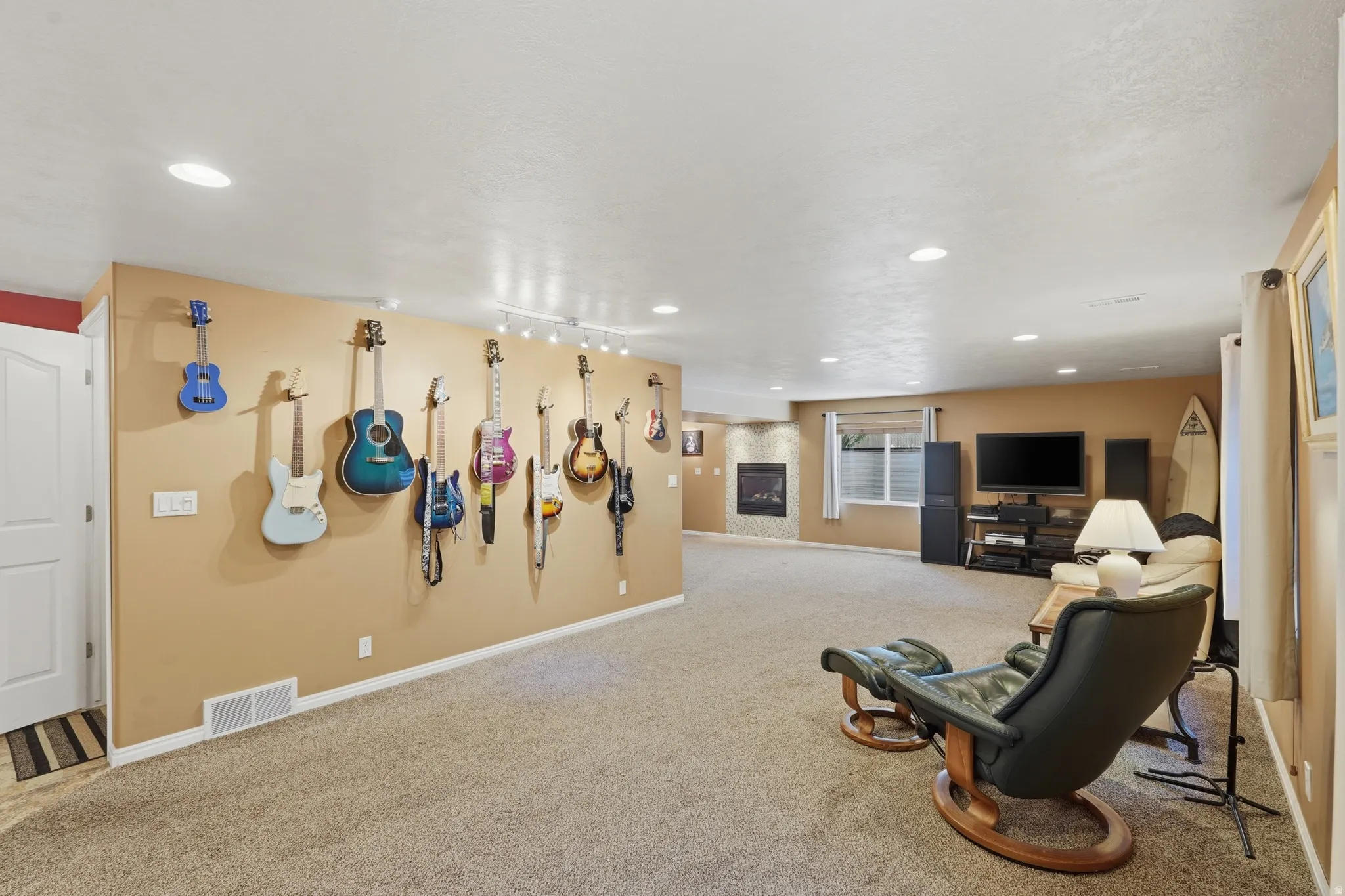 Spacious lower-level room featuring recessed lighting and neutral carpet