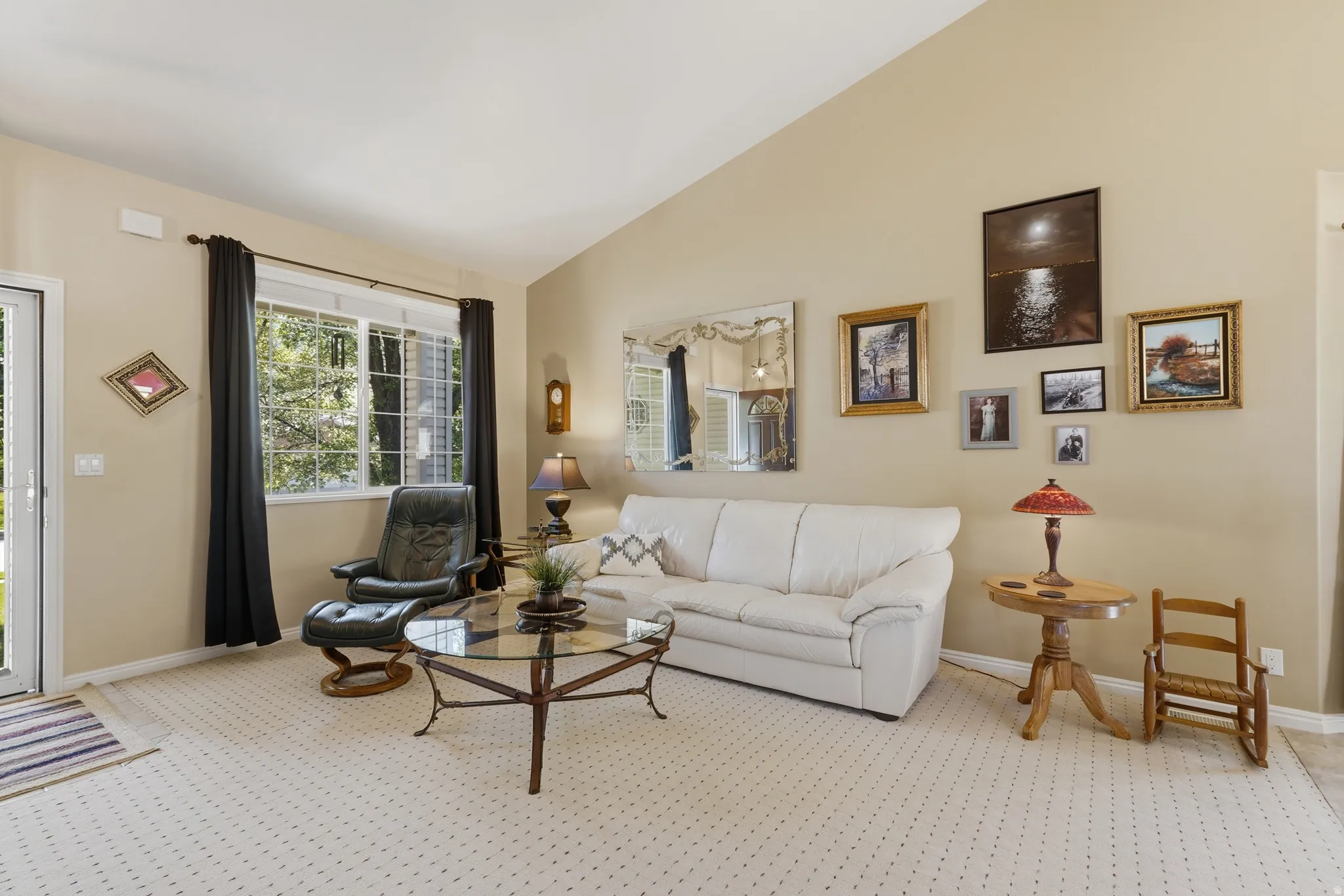 Living space featuring a vaulted ceiling and plenty of natural light