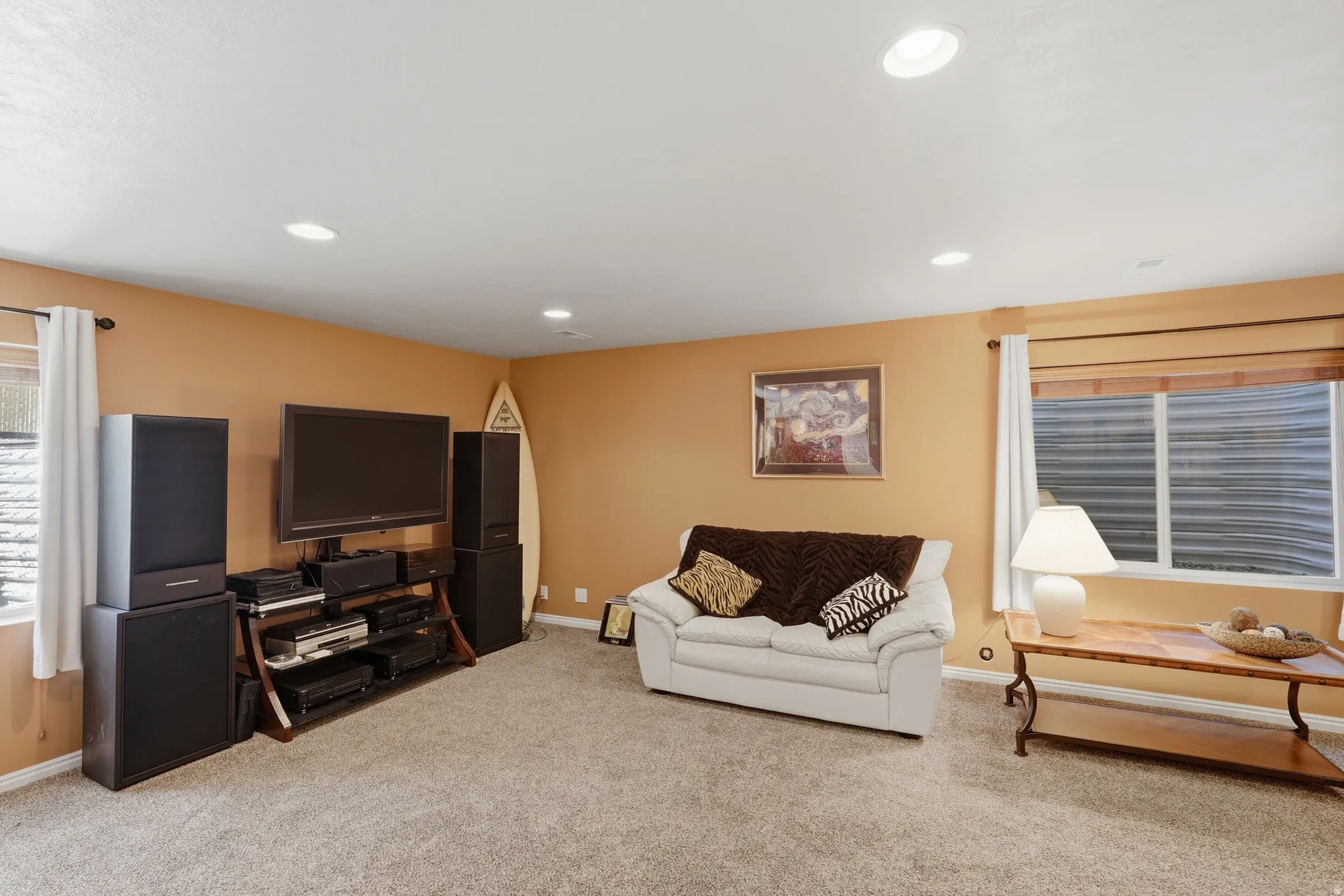 Carpeted room featuring recessed lighting and two windows