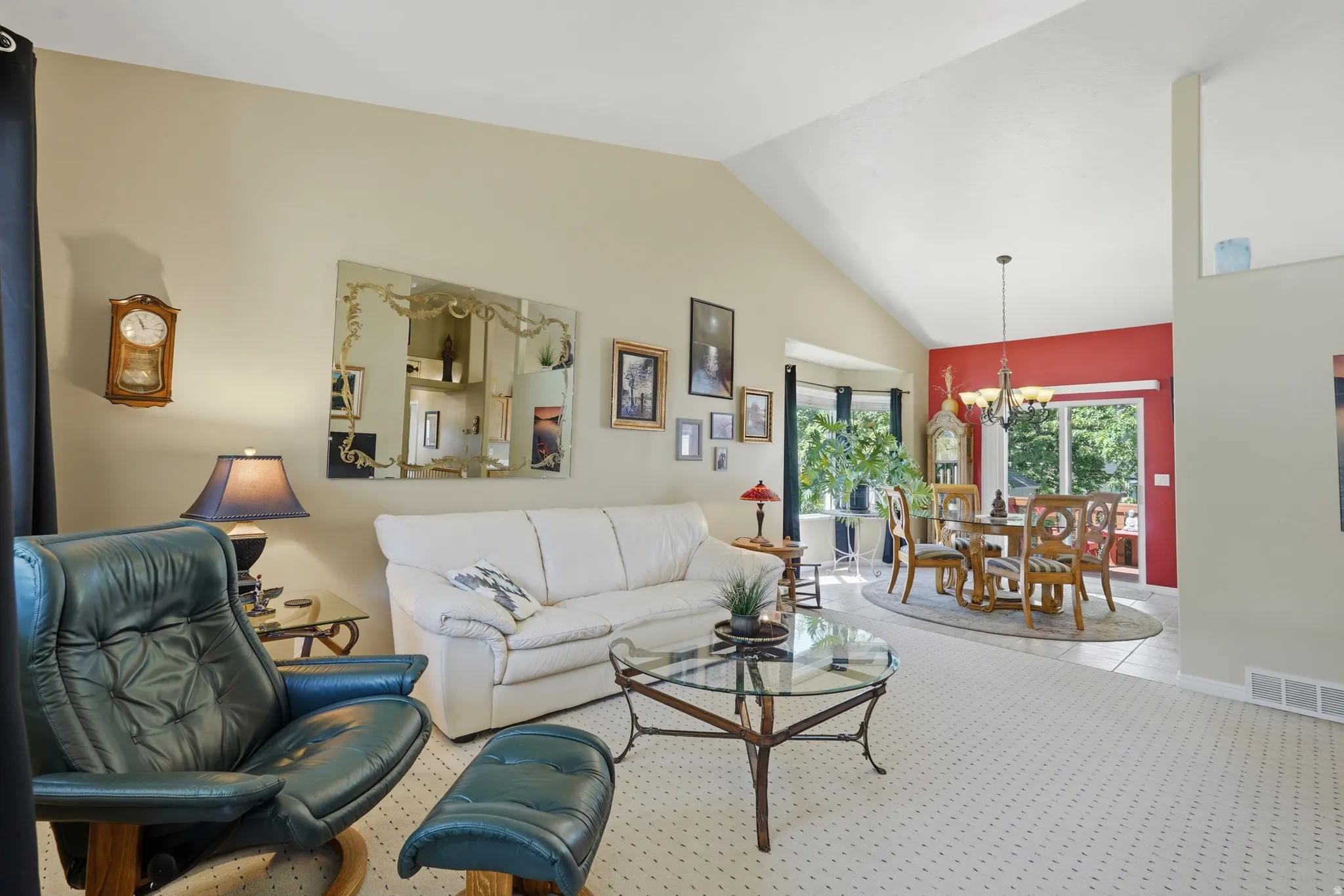 Open living room and dining area with sliding doors leading to the deck