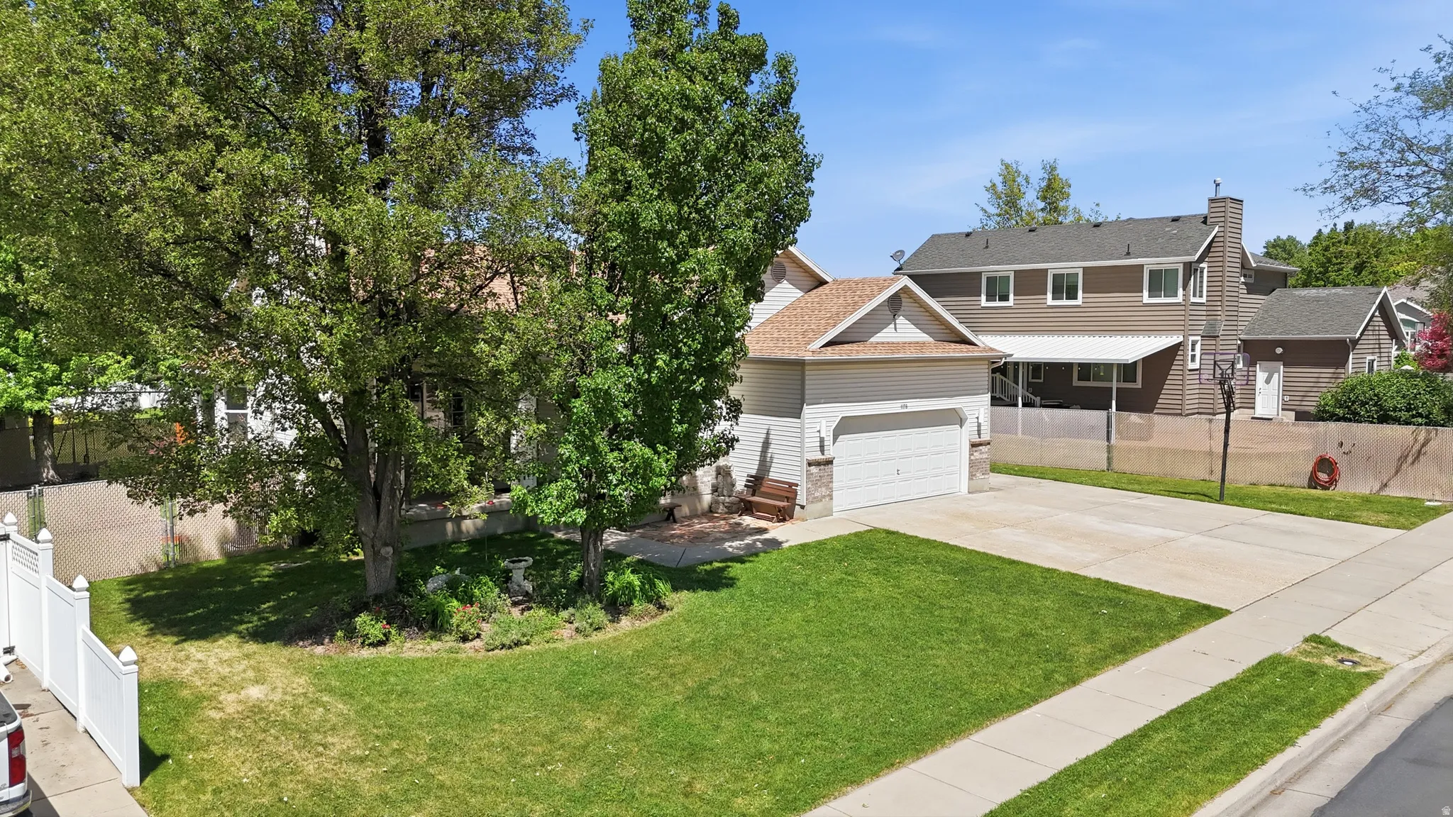 Two-story residence featuring a two-car attached garage with a stone accent facade