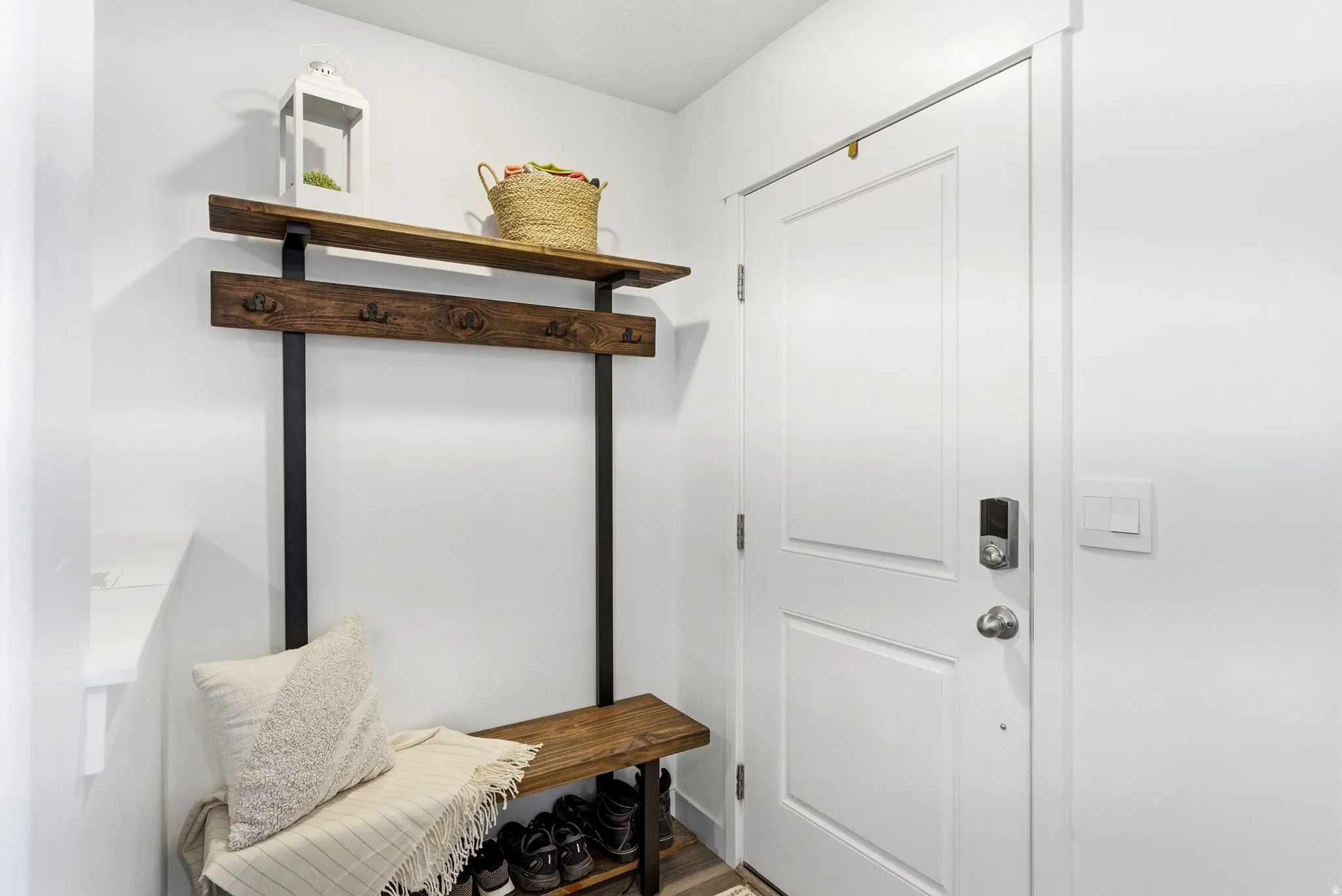 Entryway featuring a white paneled door with contemporary hardware and light switch