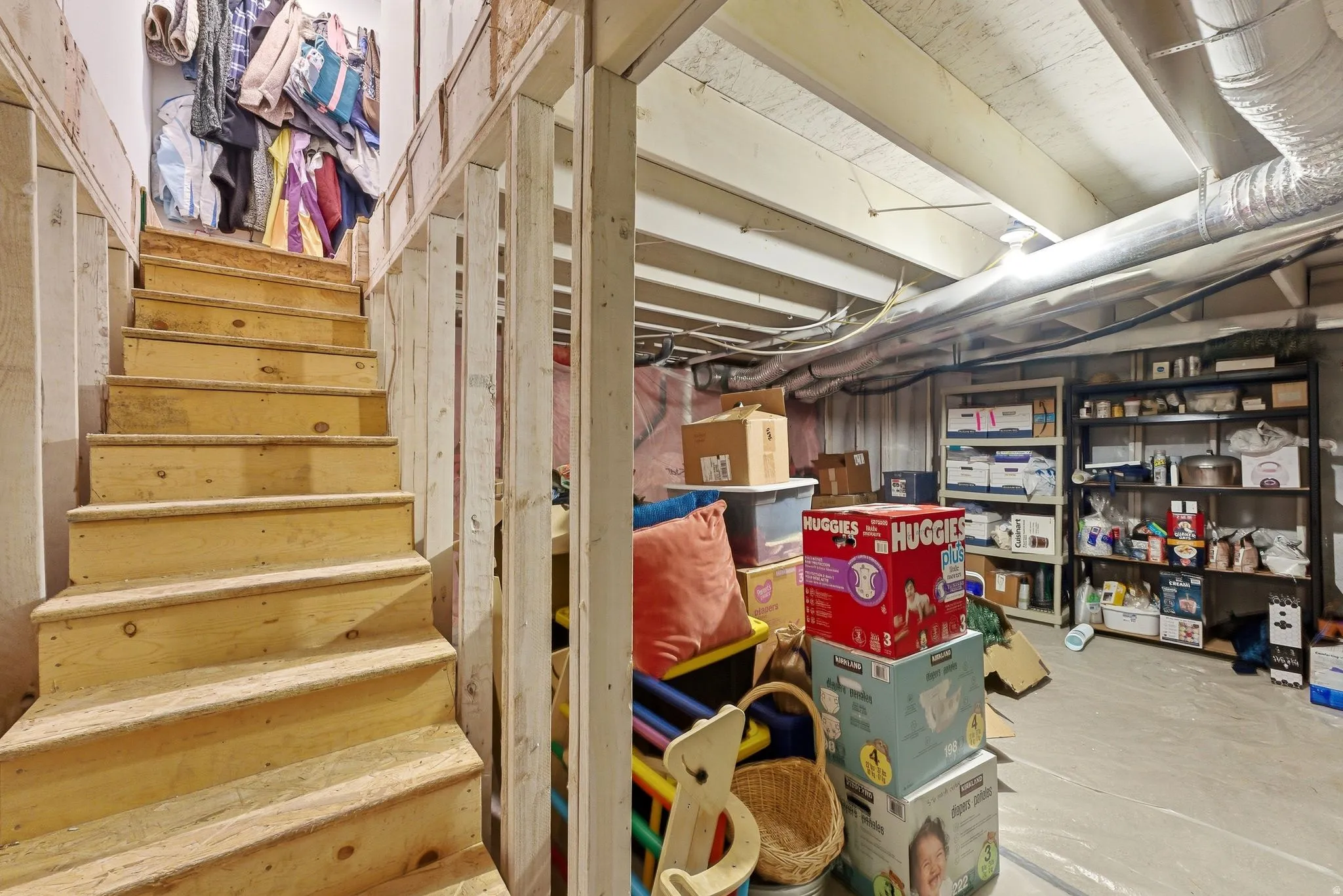 Wooden staircase with open risers and railing leading to a lower level