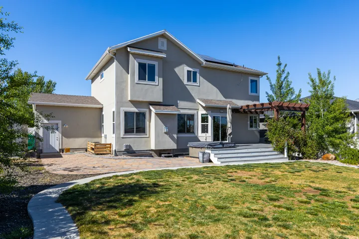 Rear exterior with light stucco finish and multiple windows