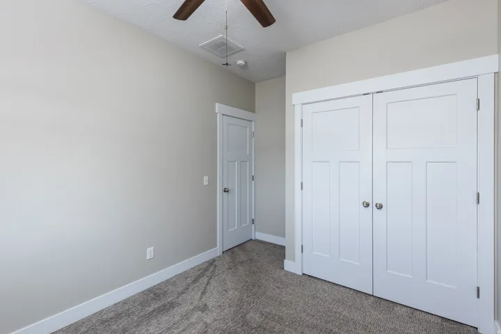 Neutral-toned walls complement the gray carpeting