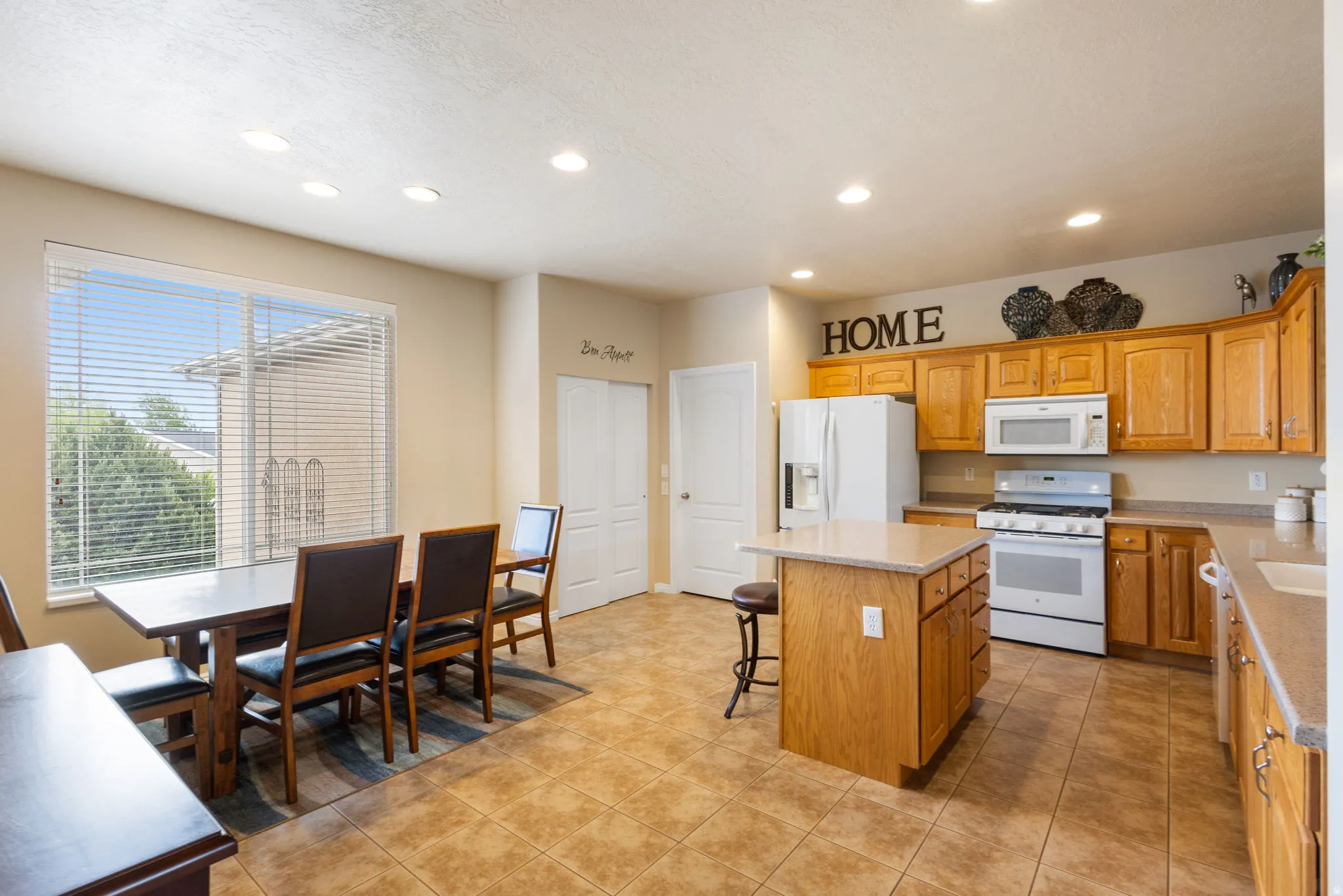 Open concept kitchen and dining area with recessed lighting and pantry