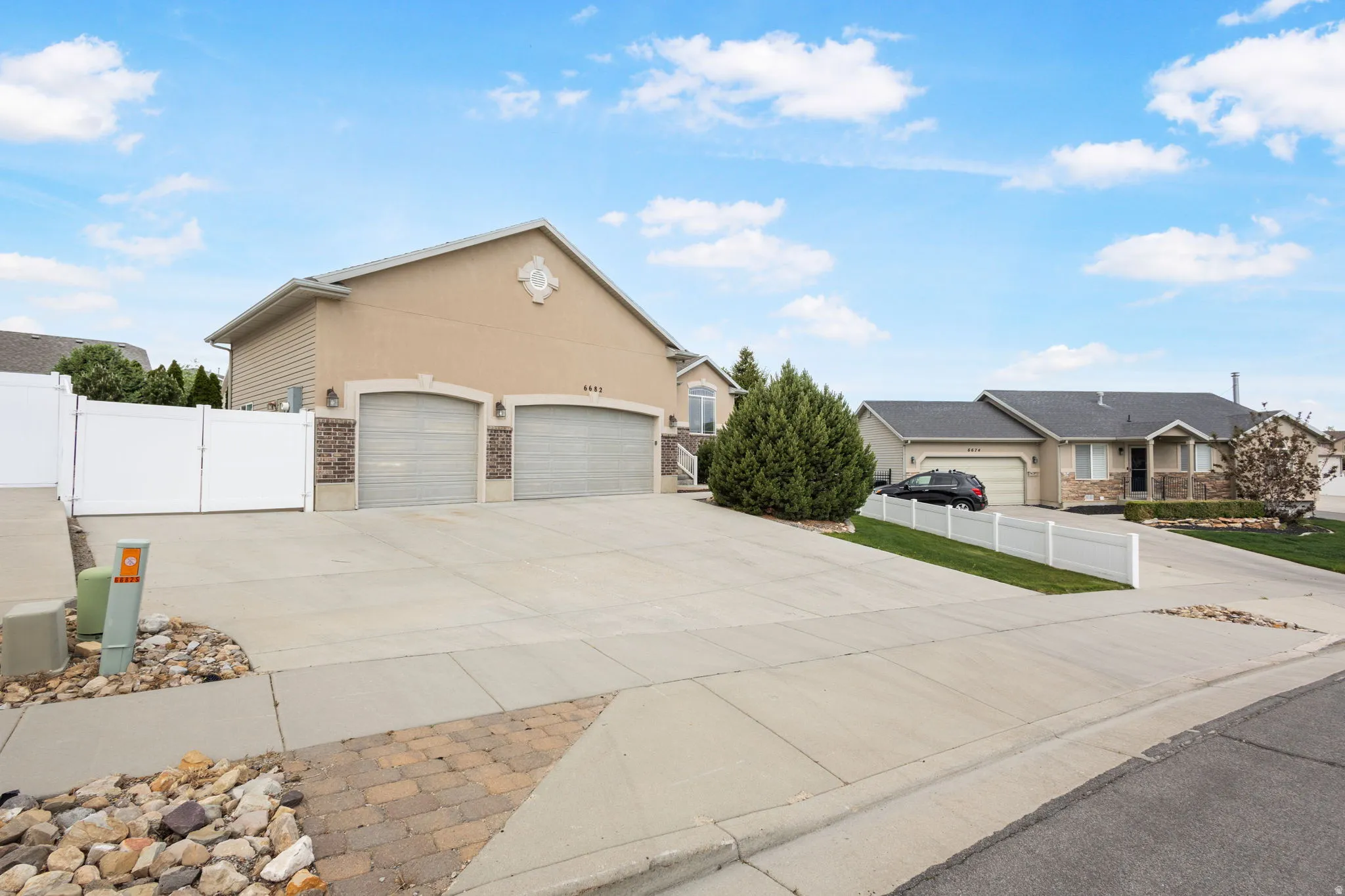 Exterior featuring a three-car garage and RV parking