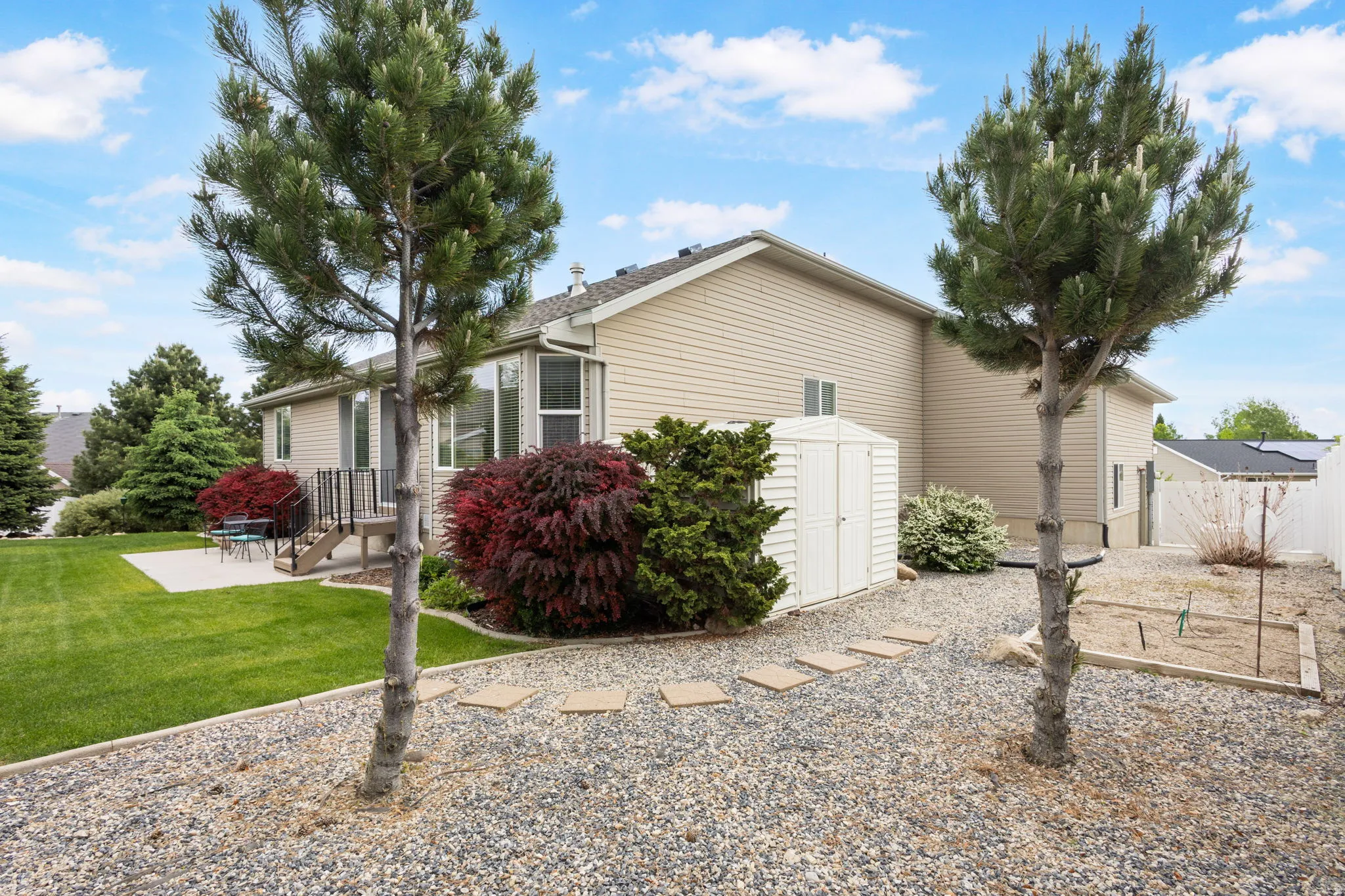 Gorgeous backyard fully fenced and lined with trees for complete privacy, and nice storage shed