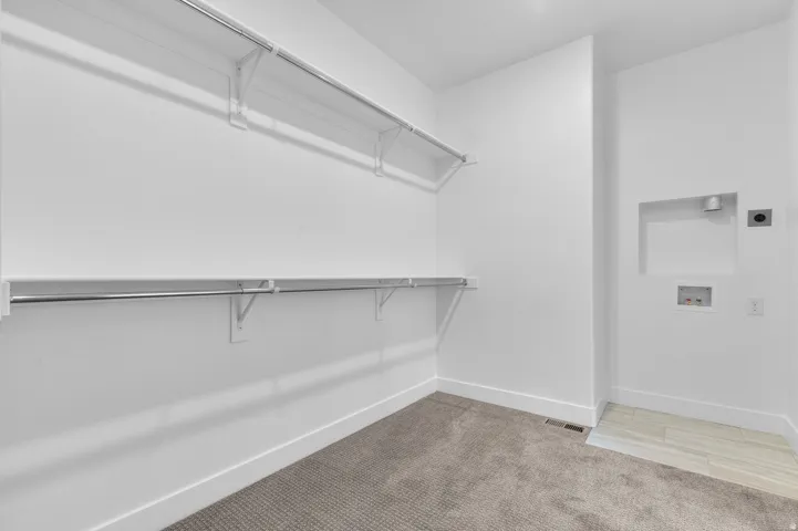 Dedicated laundry space featuring a tile floor section