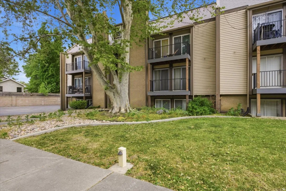 Multi-story building exterior featuring individual balconies with black metal railings