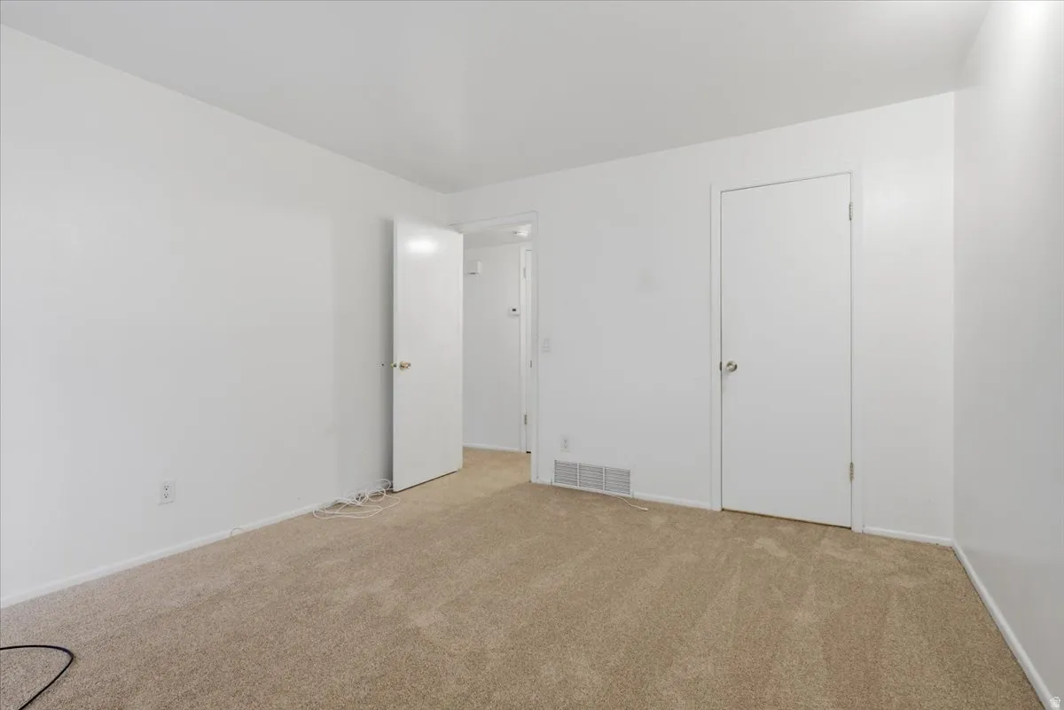 Neutral-toned carpeting and white painted walls