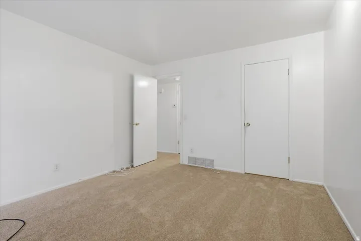 Neutral-toned carpeting and white painted walls