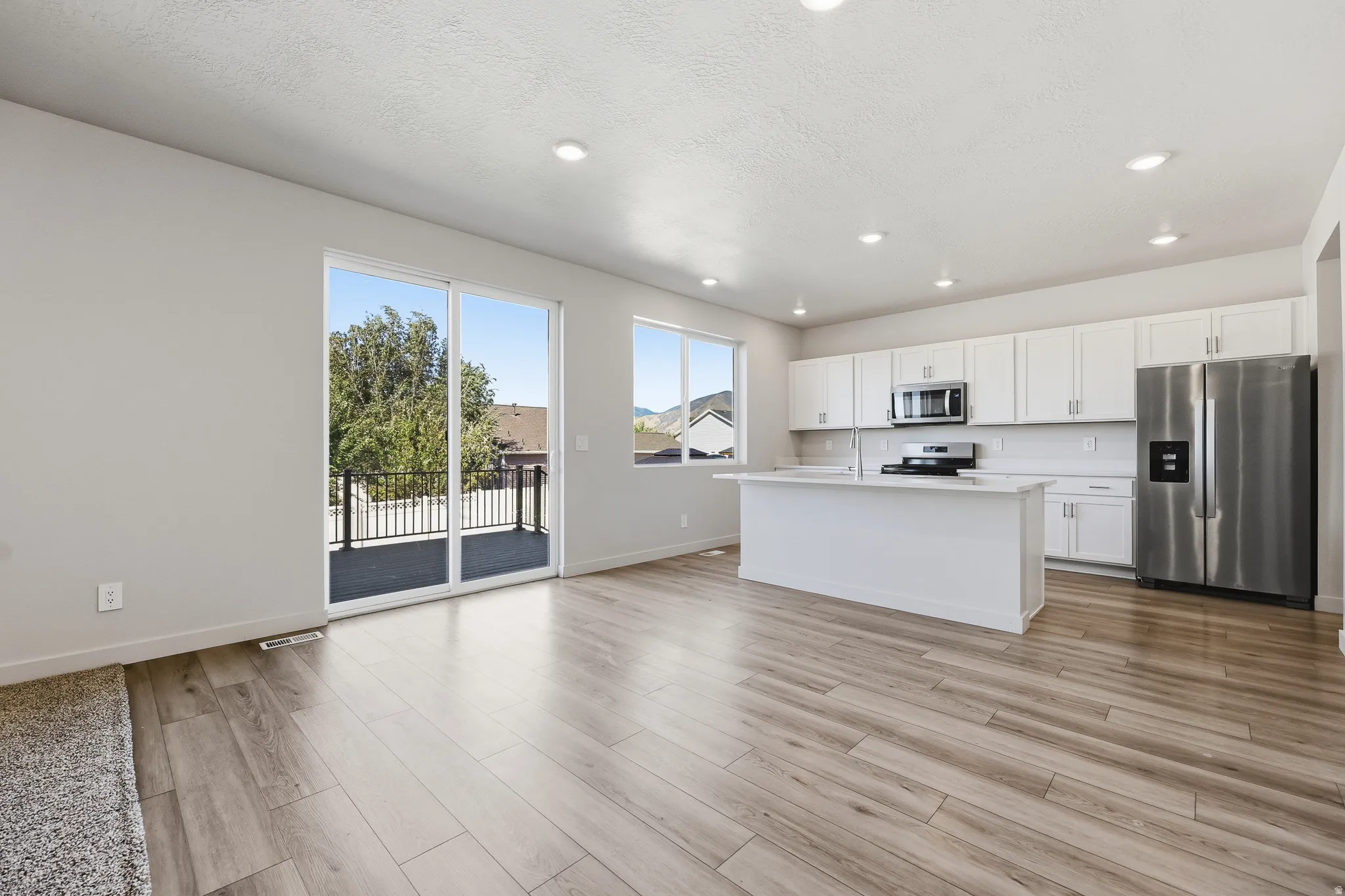 Open-concept living space with wood-finish flooring