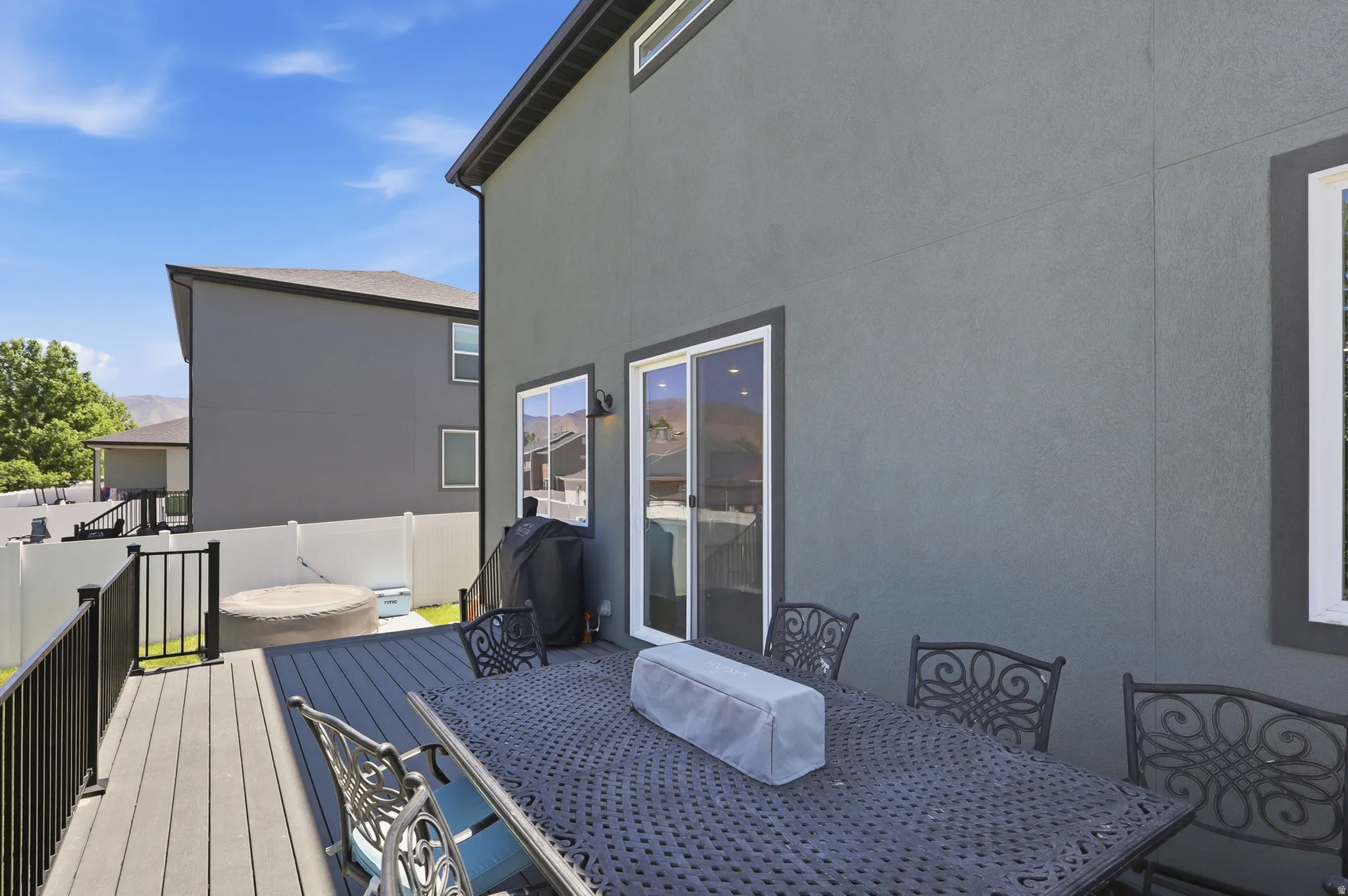 Expansive deck featuring composite decking and black metal railings