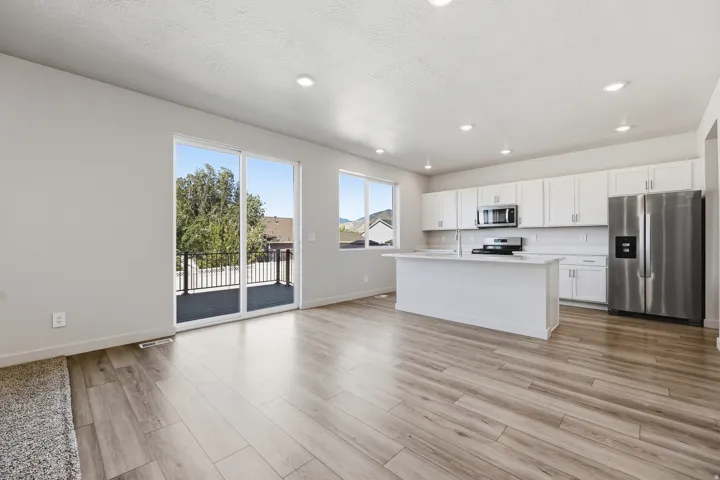 Open-concept living space with wood-finish flooring
