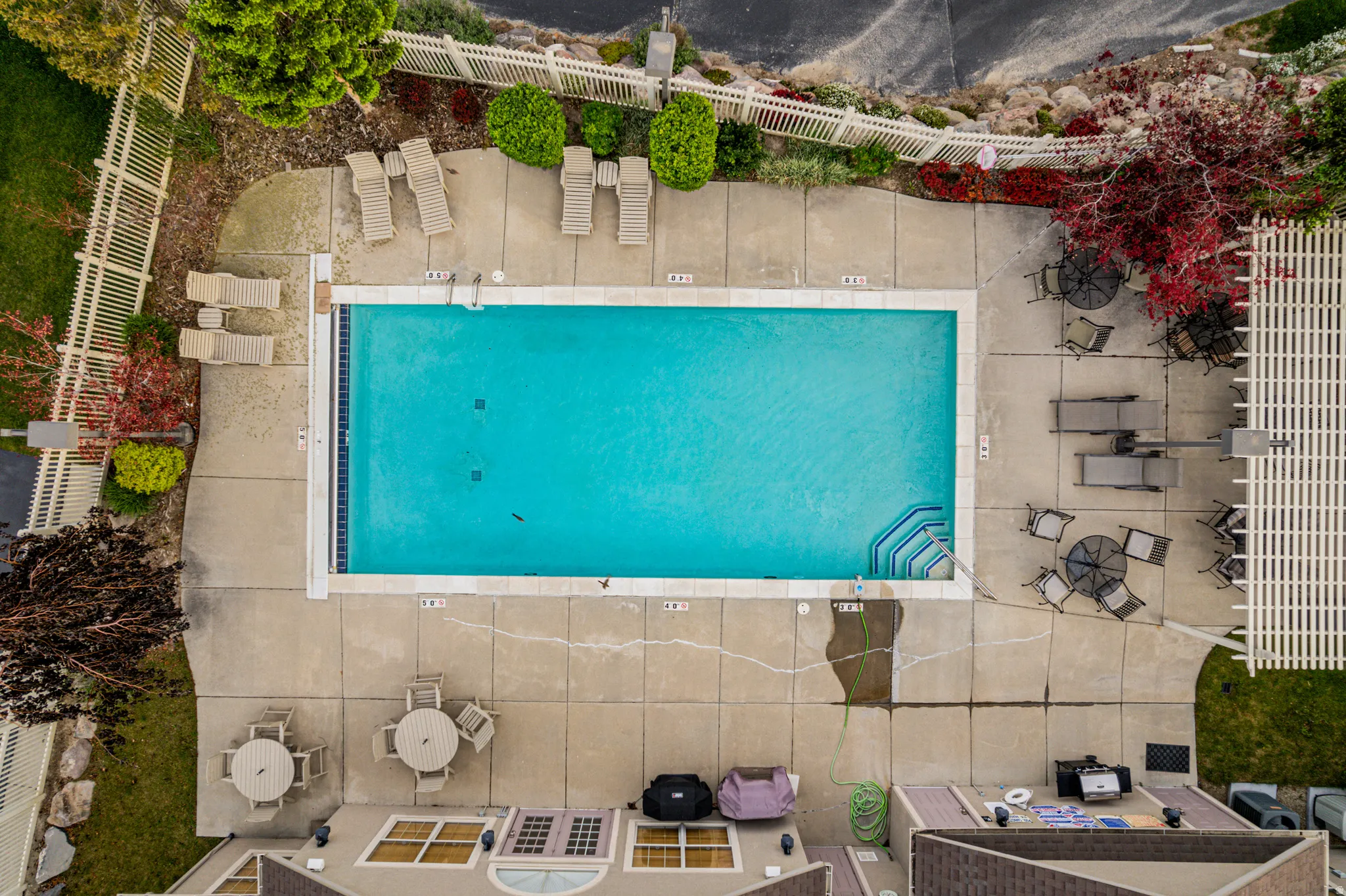 Rectangular swimming pool with integrated steps, surrounded by a concrete deck
