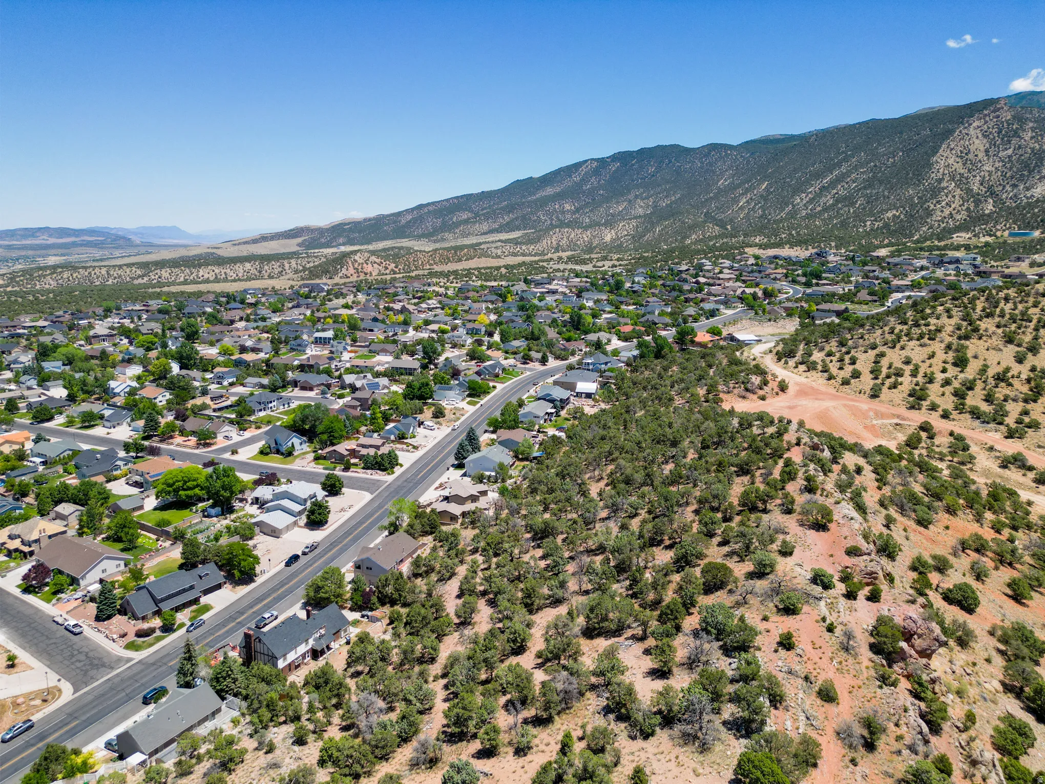 Expansive aerial perspective showcasing a residential neighborhood with surrounding natural landscapes