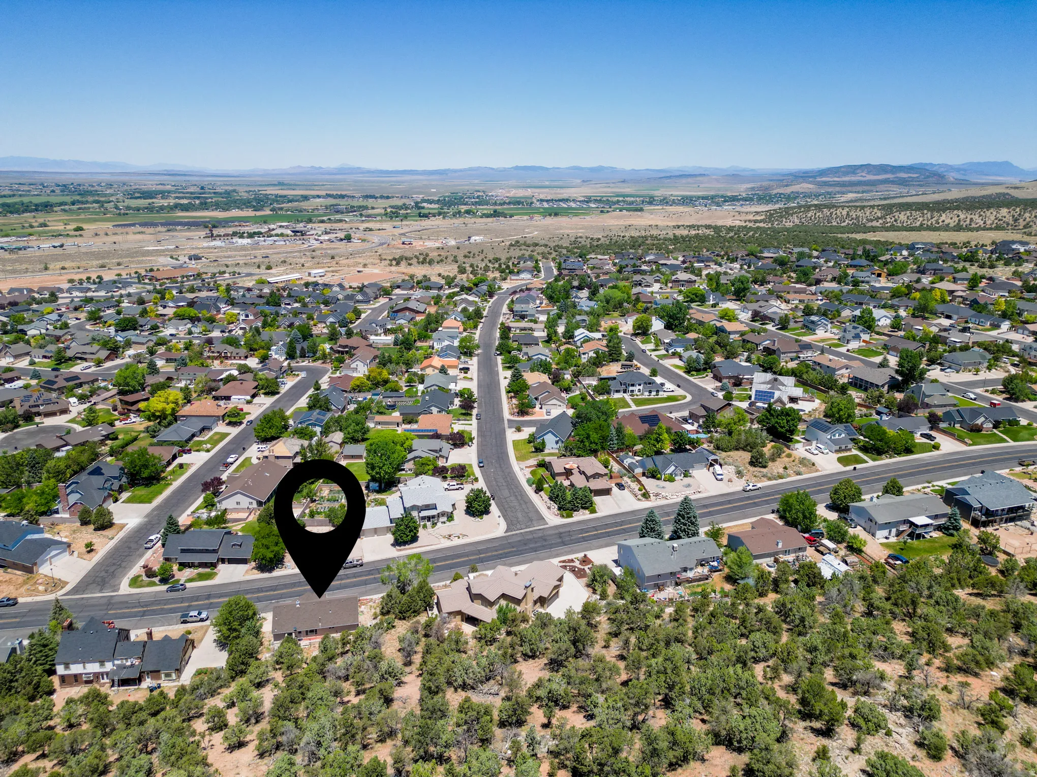 Residential neighborhood featuring a variety of single-family homes, paved roads, and mature landscaping