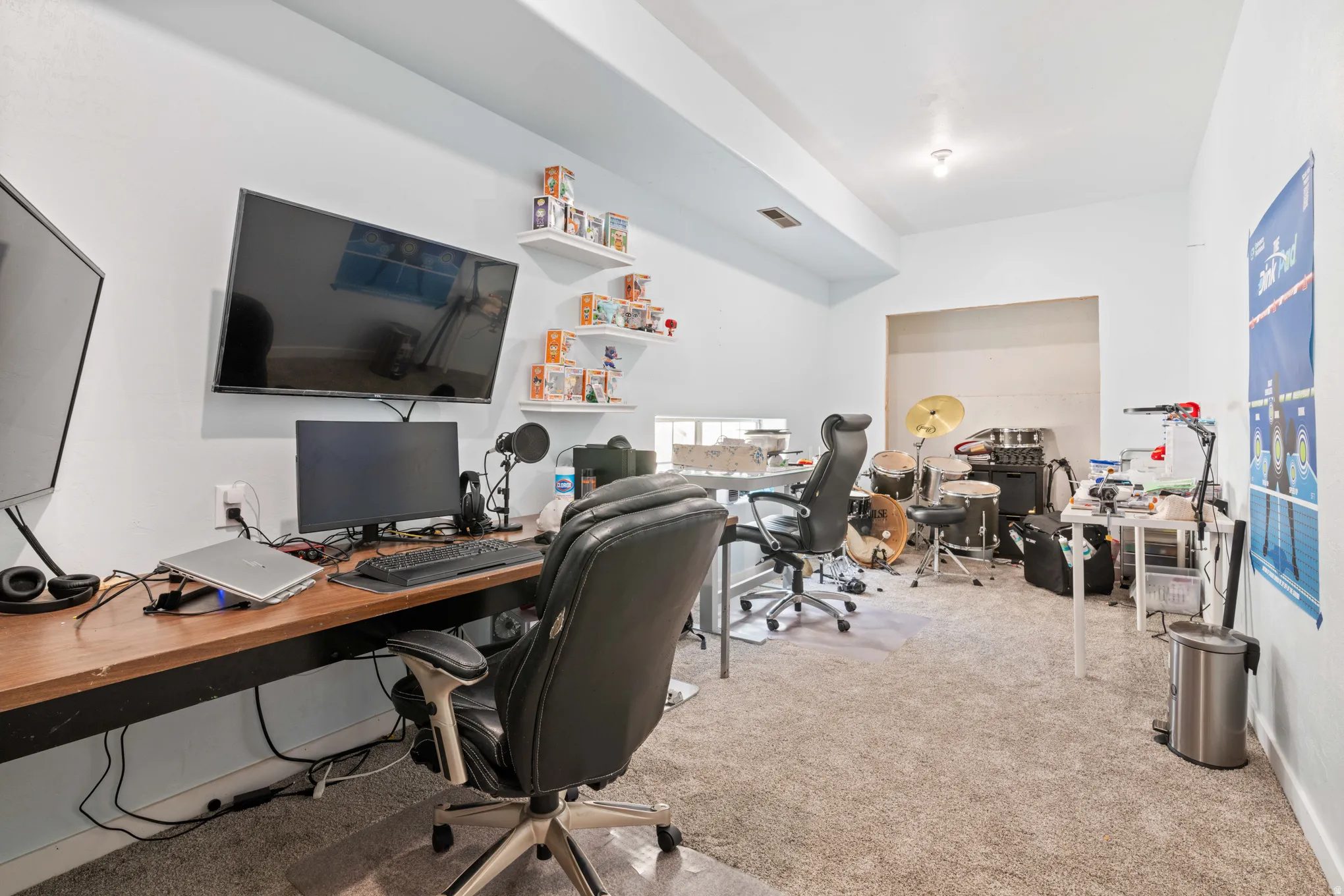 Versatile room featuring light carpeting and white painted walls