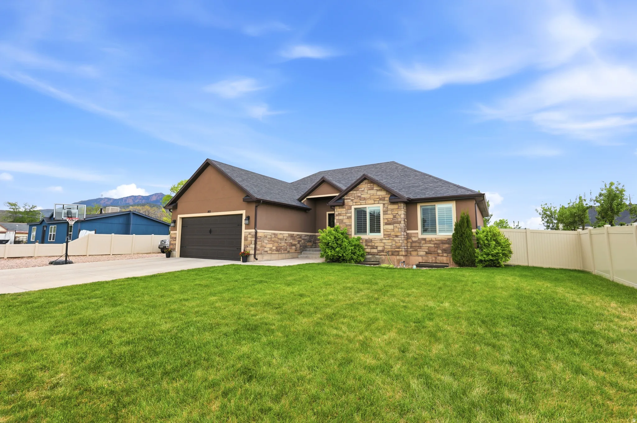 Exterior featuring a combination of stone veneer and stucco siding