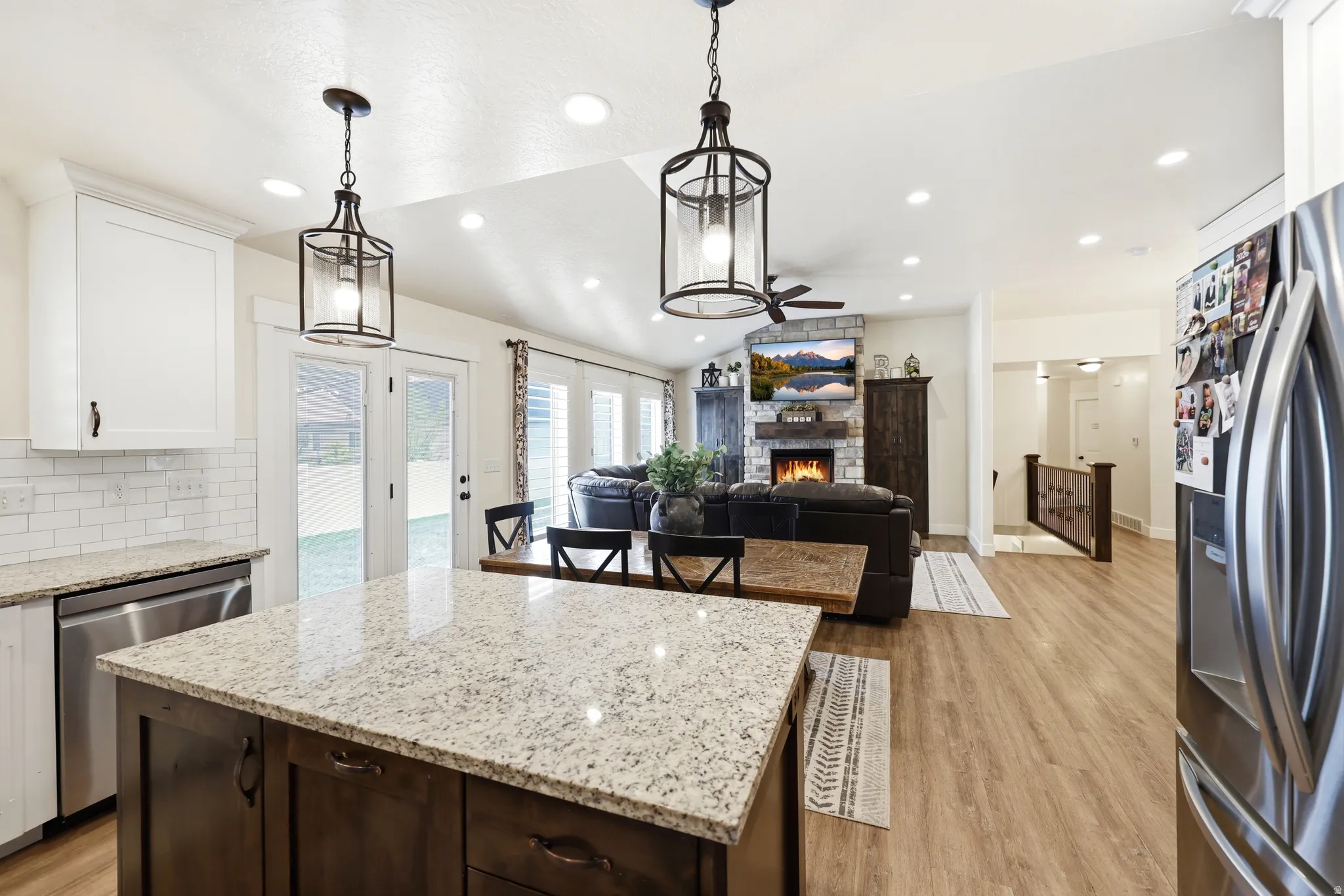Kitchen island with granite countertop and dark wood cabinetry