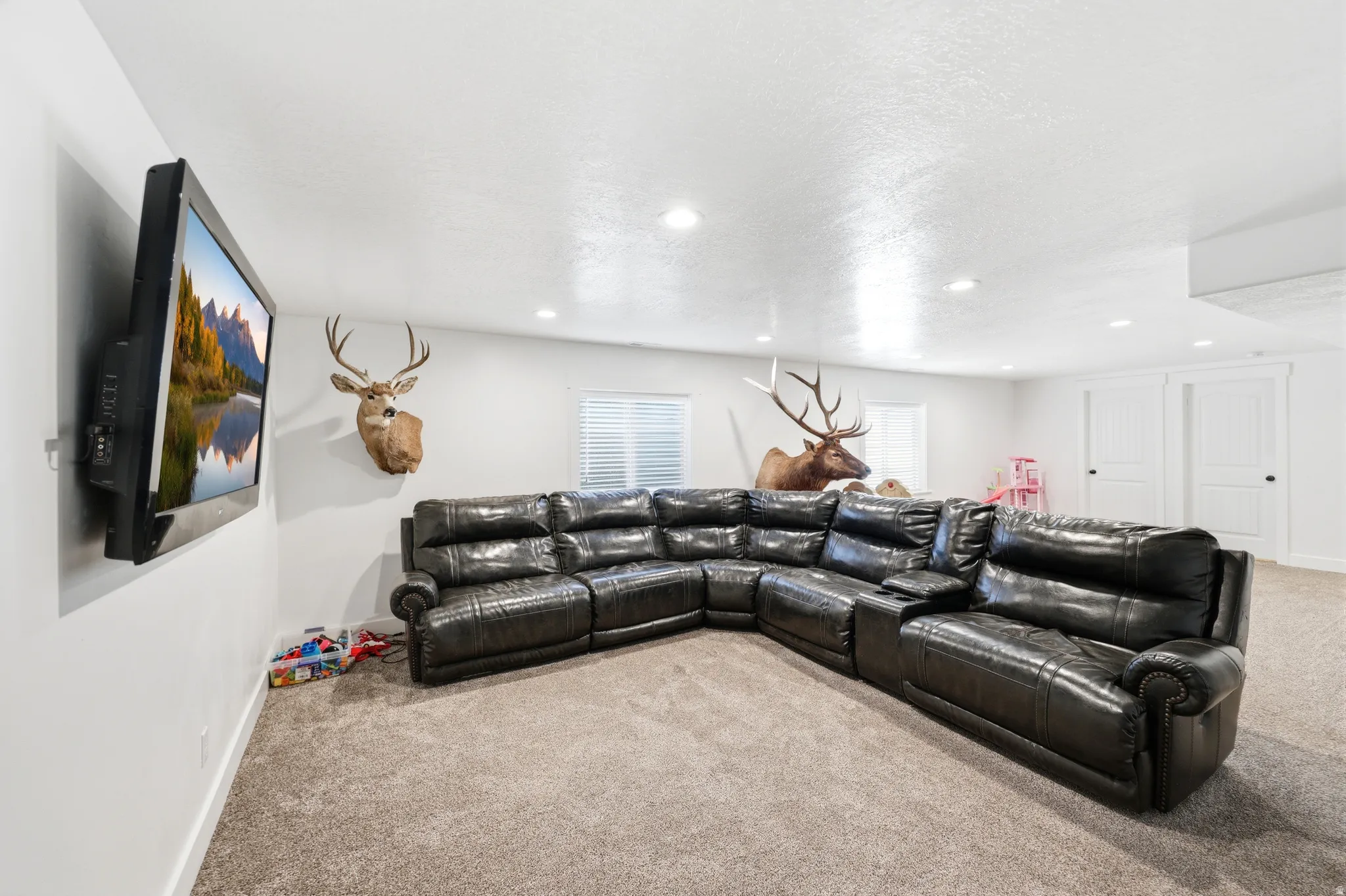 Carpeted room featuring recessed lighting and white walls