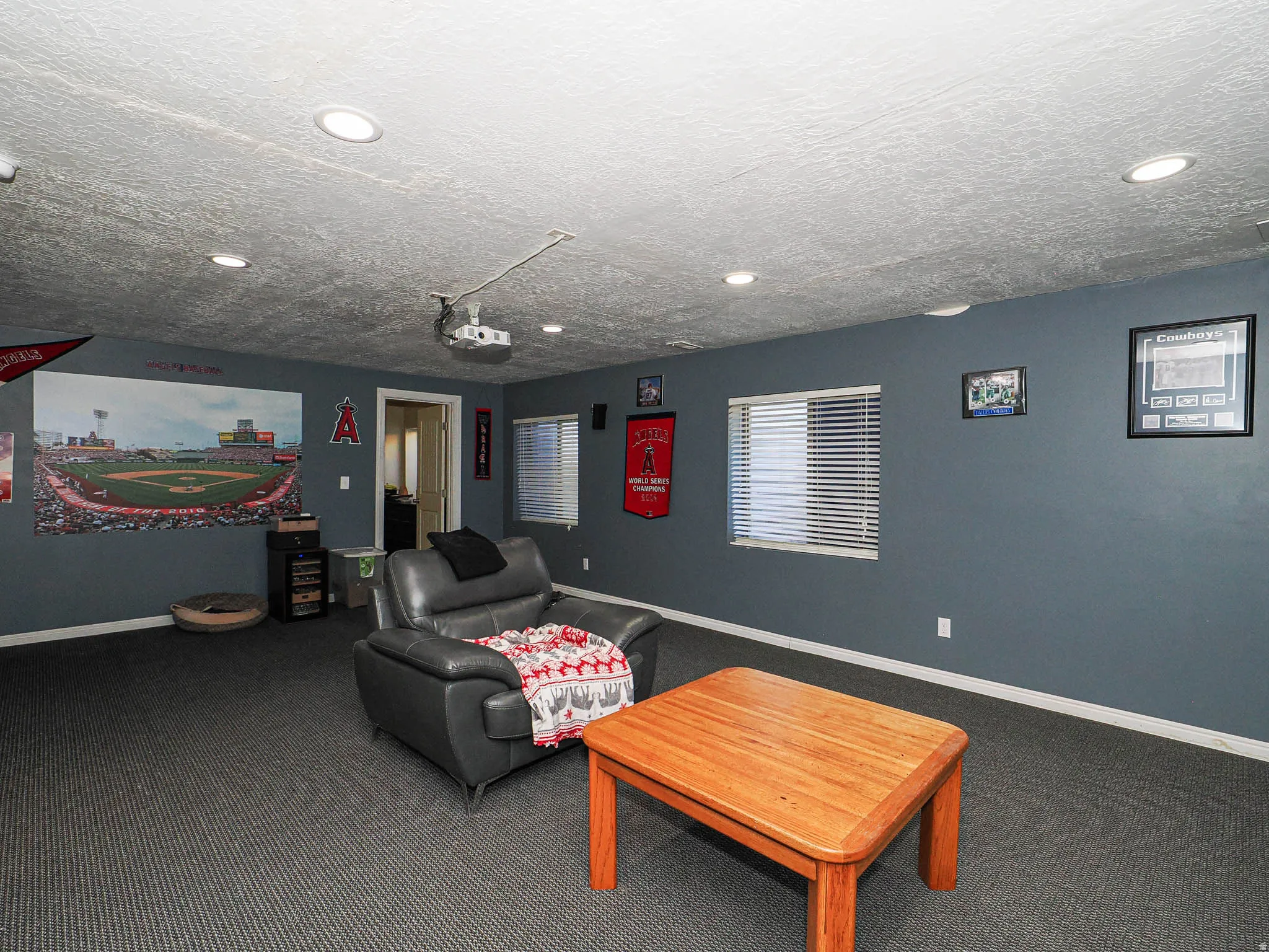Spacious room featuring recessed lighting, two windows with blinds, and durable carpeting
