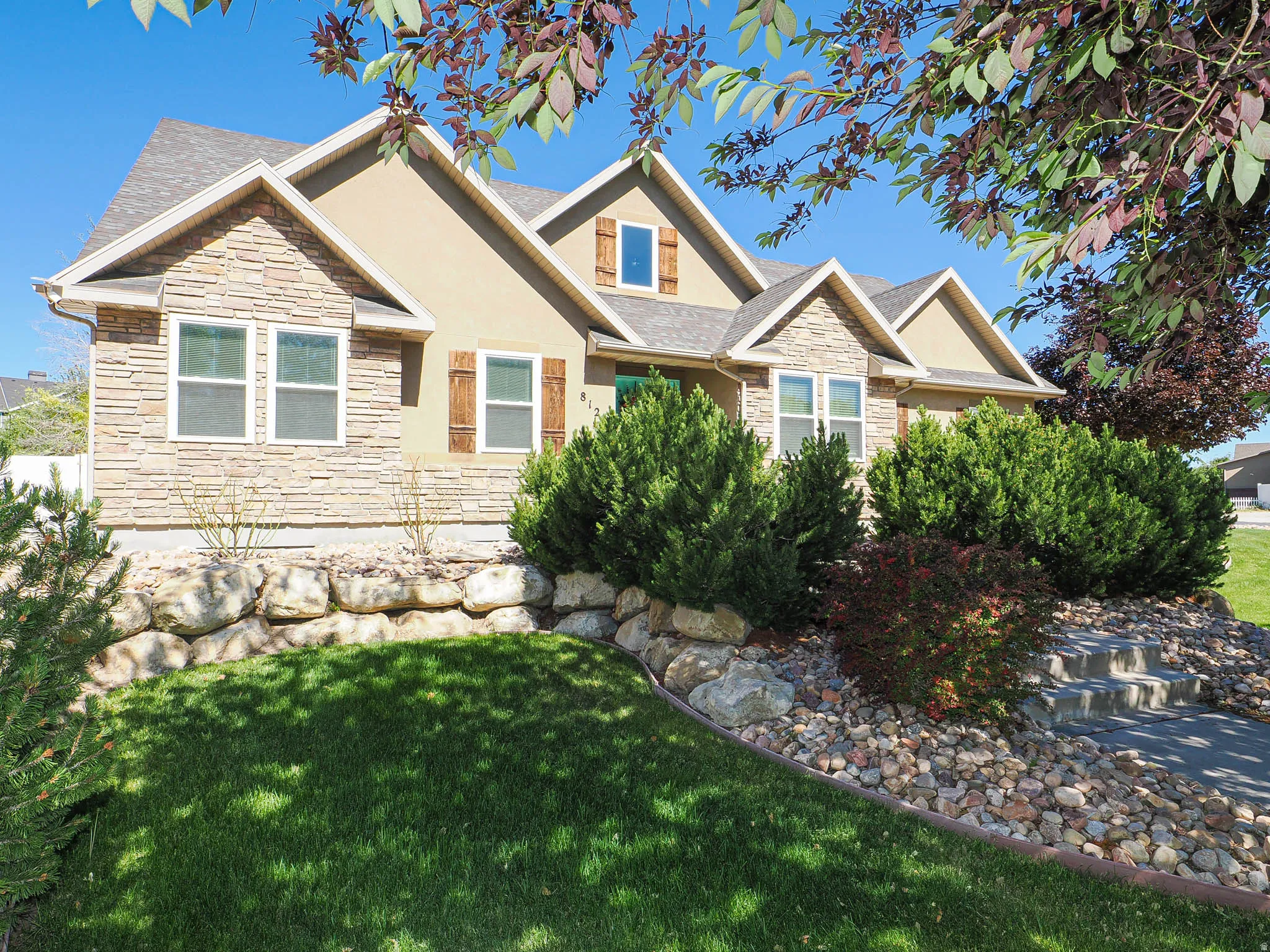 Exterior featuring stone veneer and stucco siding