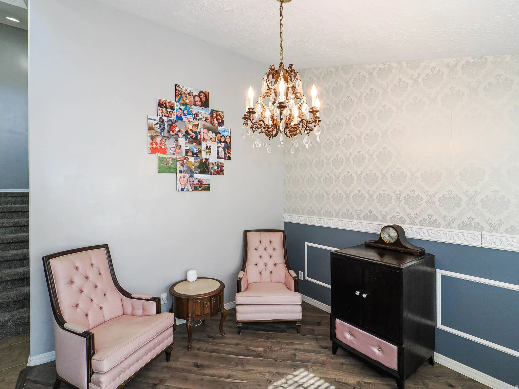 Interior space featuring wood-finish flooring, a decorative chandelier, and a chair rail with panel molding