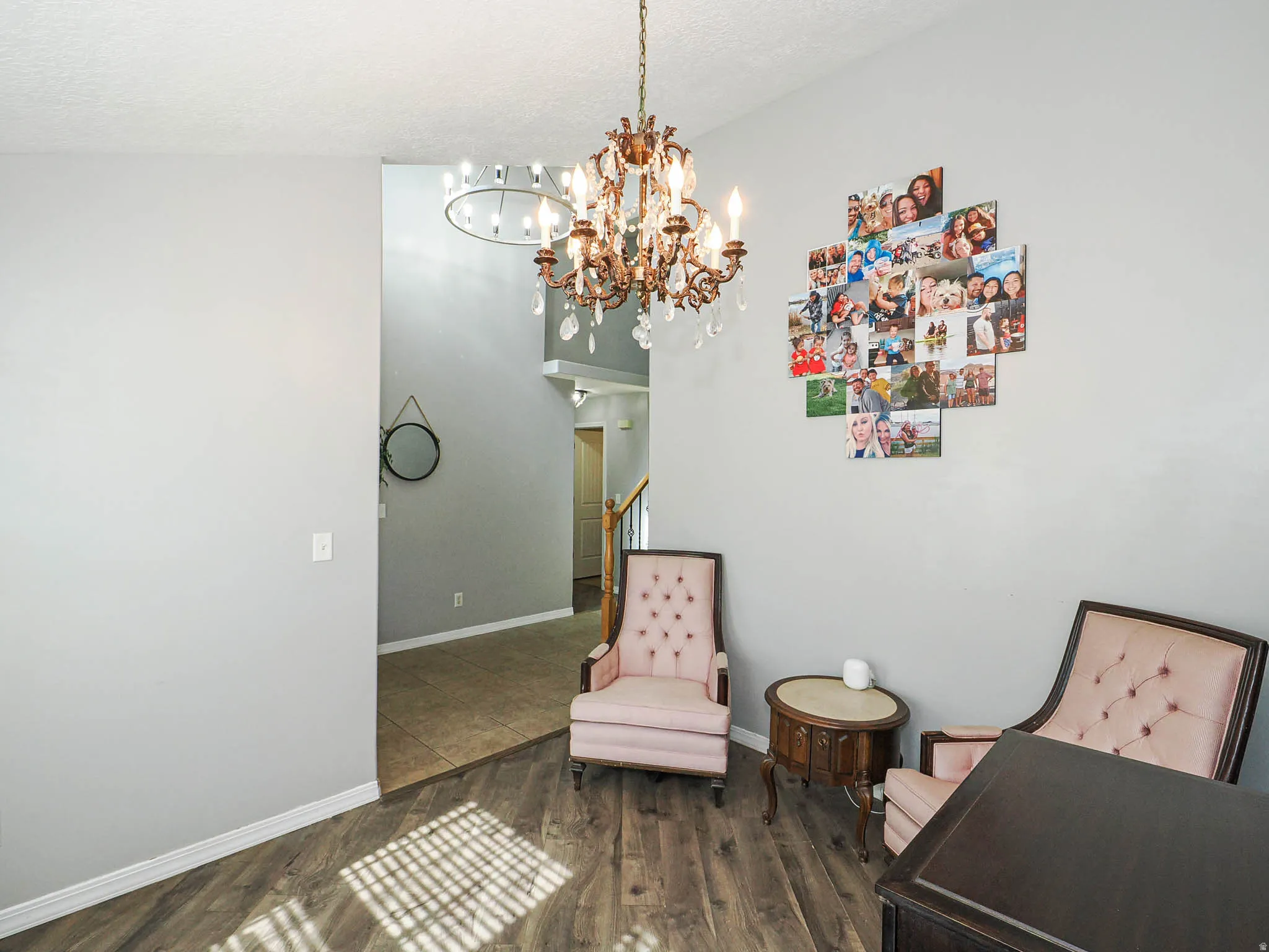 Interior space featuring wood-finish flooring, light gray wall paint, and a decorative chandelier