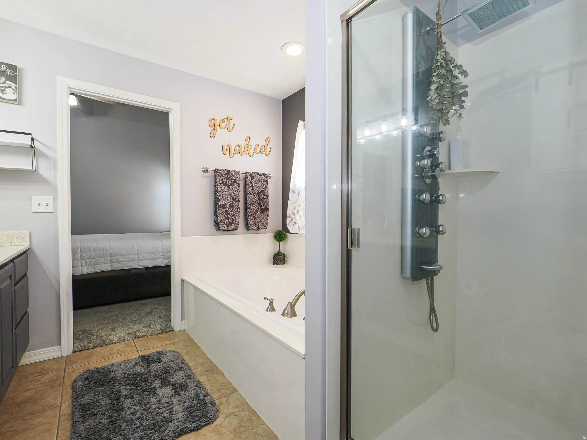 Walk-in shower with glass enclosure and multi-function shower panel